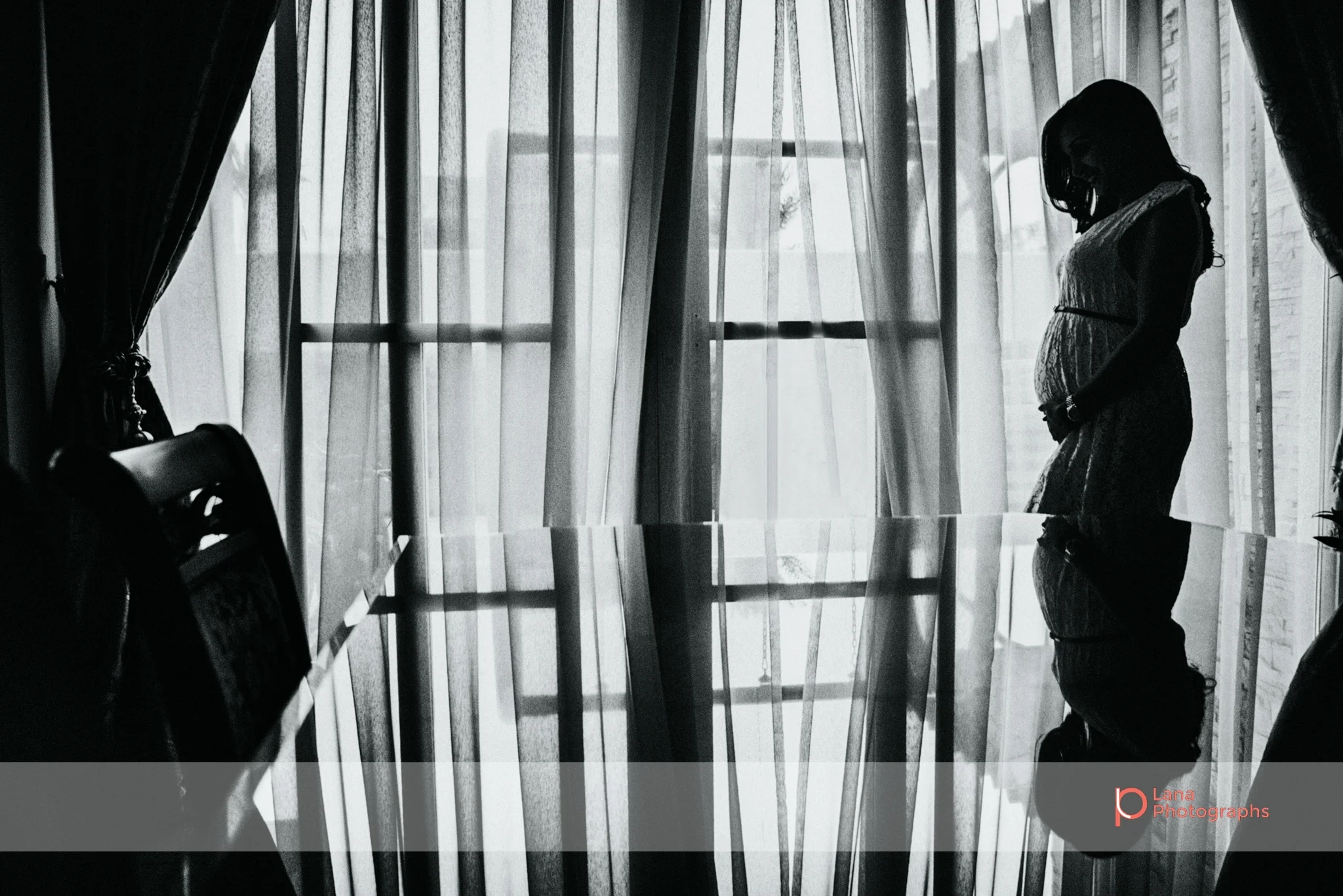 Lana Photographs Maternity Photography Dubai Professional Maternity Photographer silhouette of pregnant woman by the window