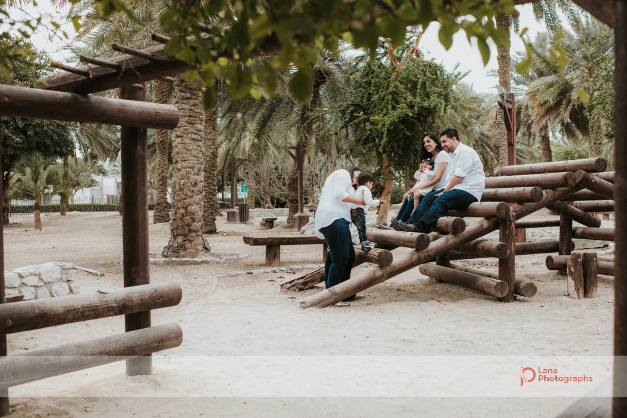Lana Photographs Family Photographer Dubai Top Family Photographers family sitting in the park on benches