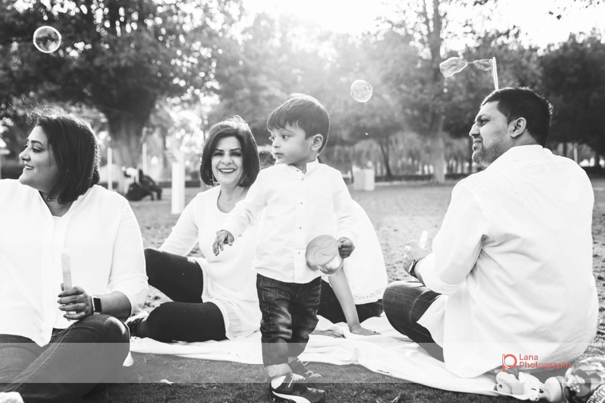 Lana Photographs Family Photographer Dubai Top Family Photographers family enjoying bubbles in the park