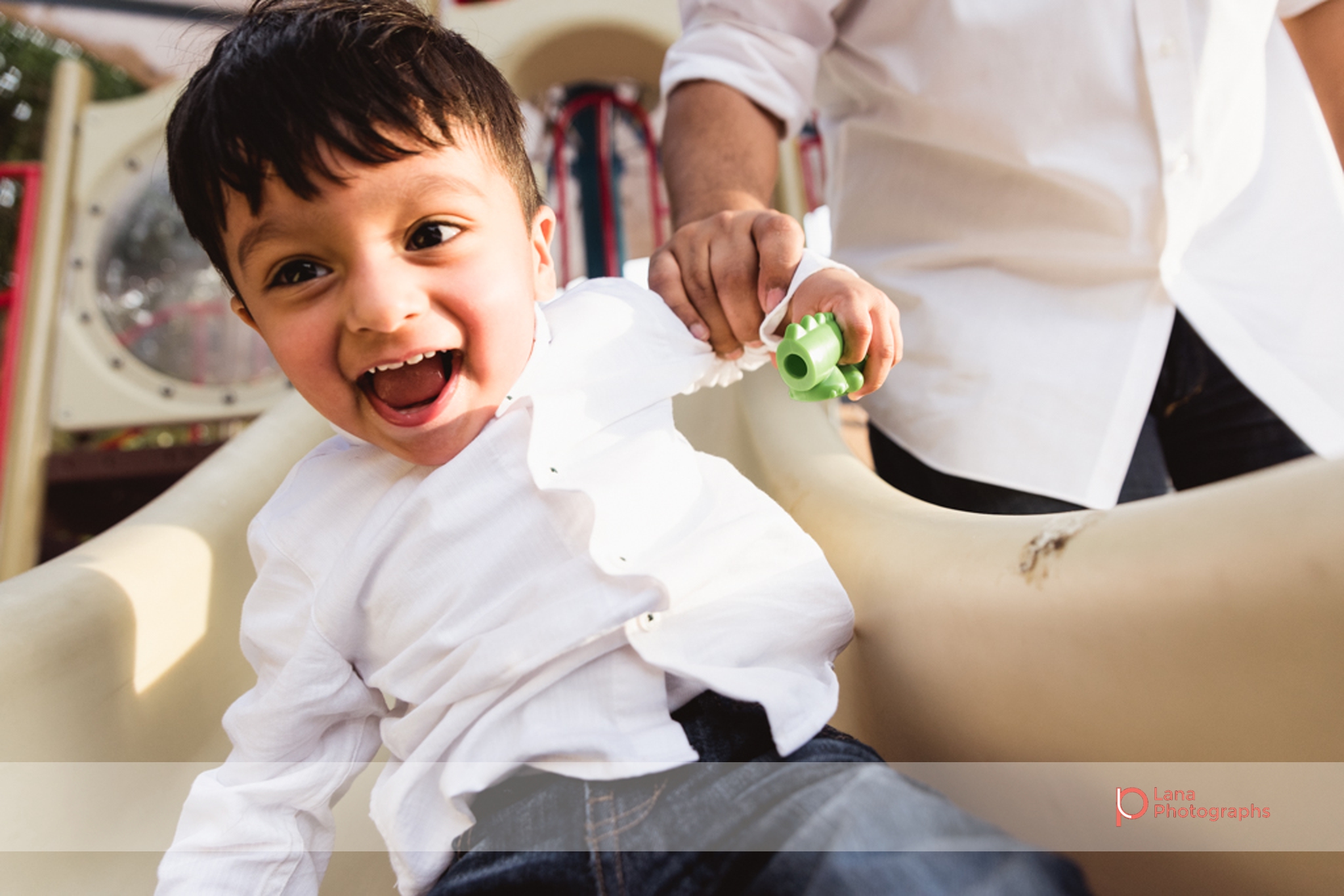 Lana Photographs Family Photographer Dubai Top Family Photographers baby boy sliding in the park