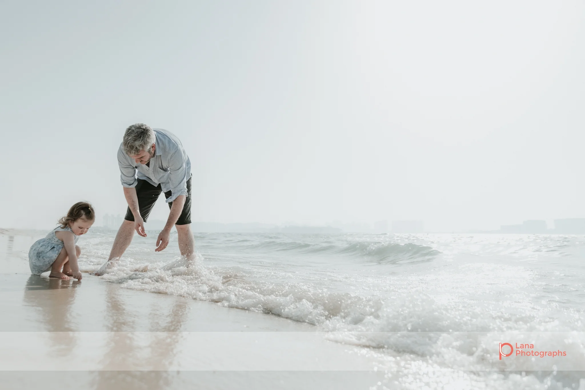 Lana Photographs Maternity Photography Dubai Professional Maternity Photographer father and daughter playing on the shore