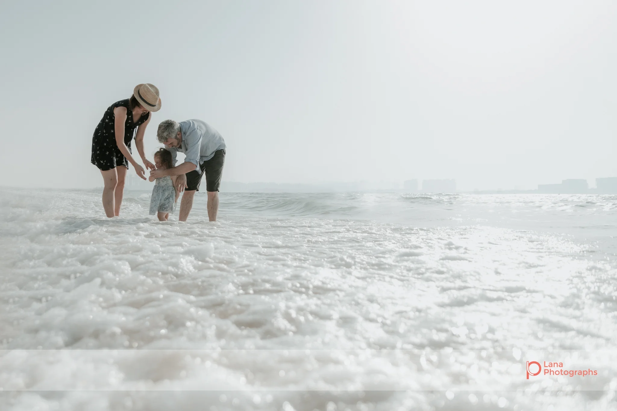 Lana Photographs Maternity Photography Dubai Professional Maternity Photographer family playing in the water