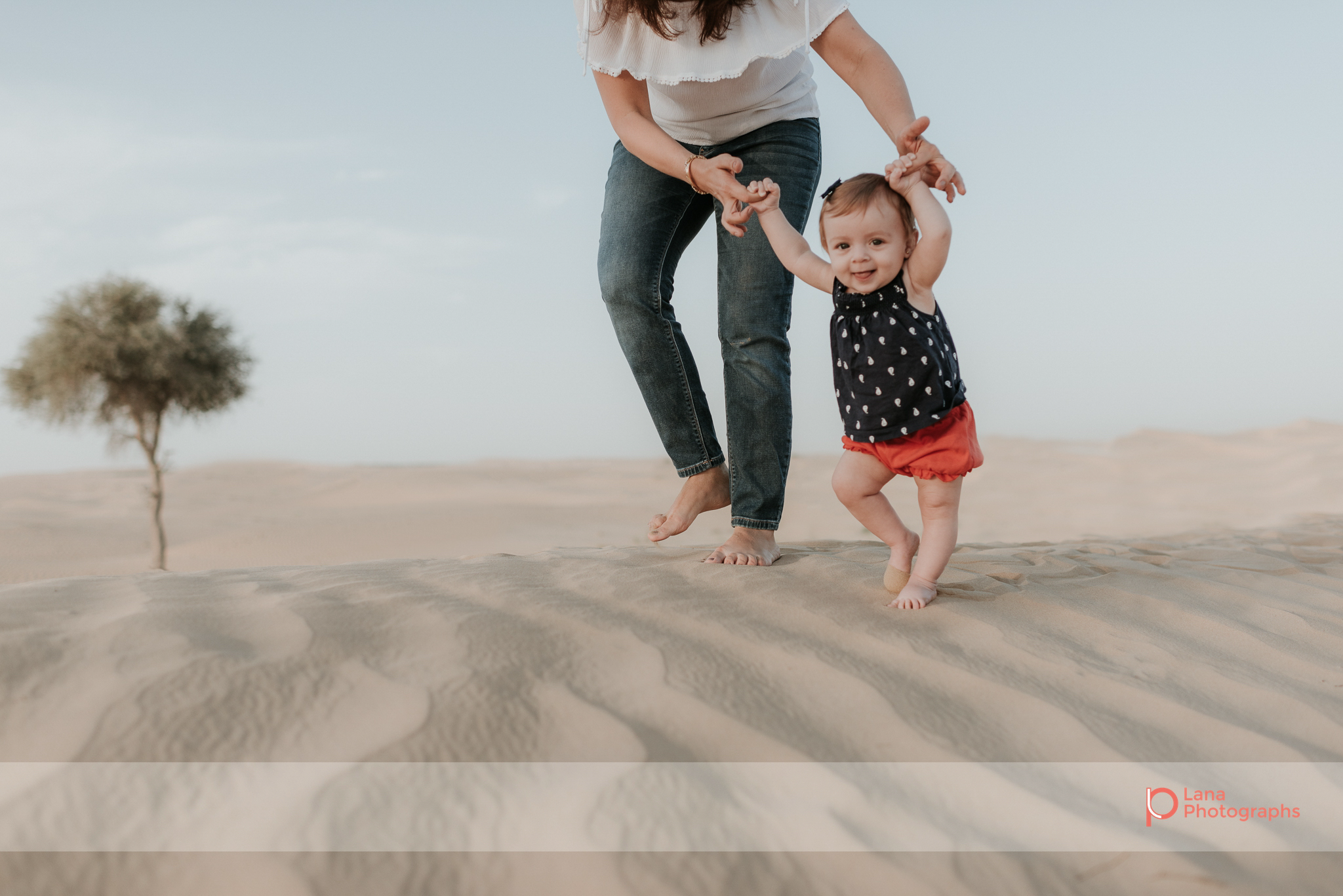 Lana Photographs Family Photographer Dubai Top Family Photographers mother walking her daughter in the desert