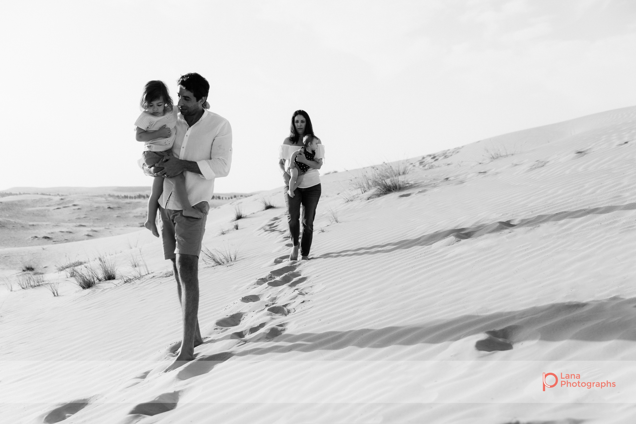  Lana Photographs Family Photographer Dubai Top Family Photographers family of four walking in the desert