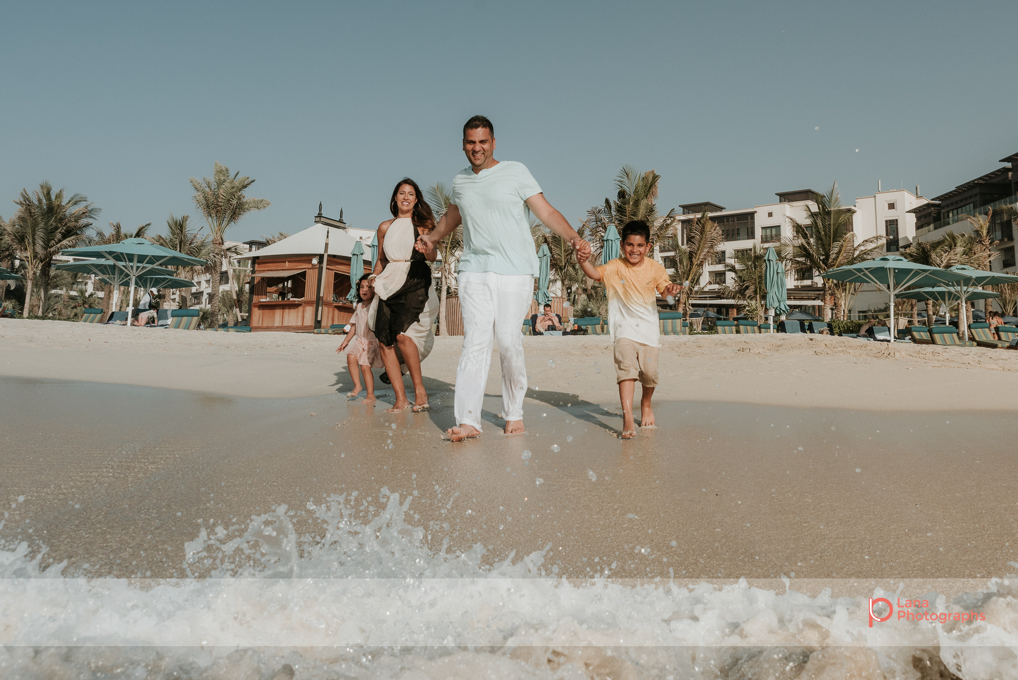  Lana Photographs Dubai Family Photography beach photoshoot family running into the water 