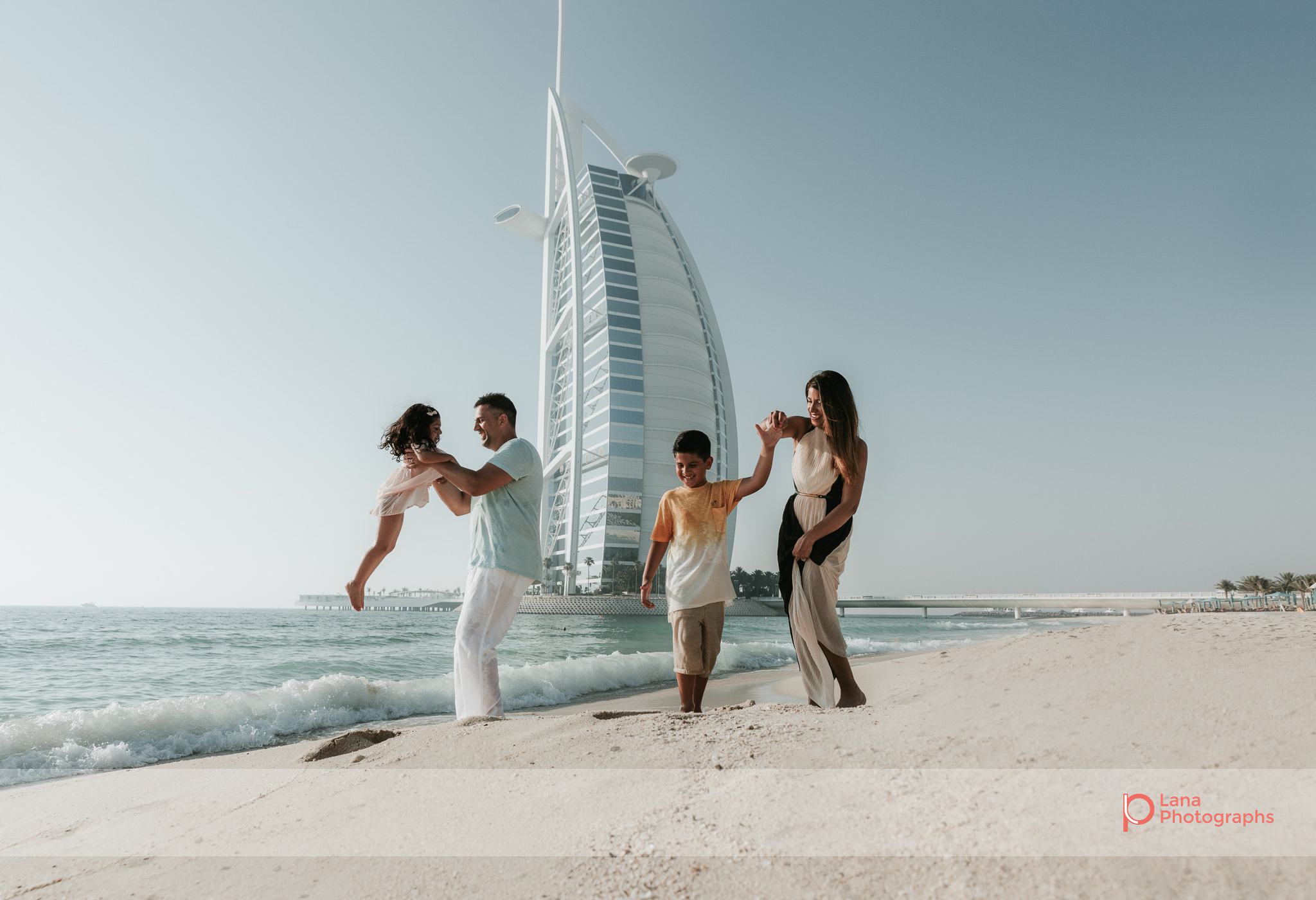 Lana Photographs Dubai Family Photography beach photoshoot family shot with burj al arab in the background