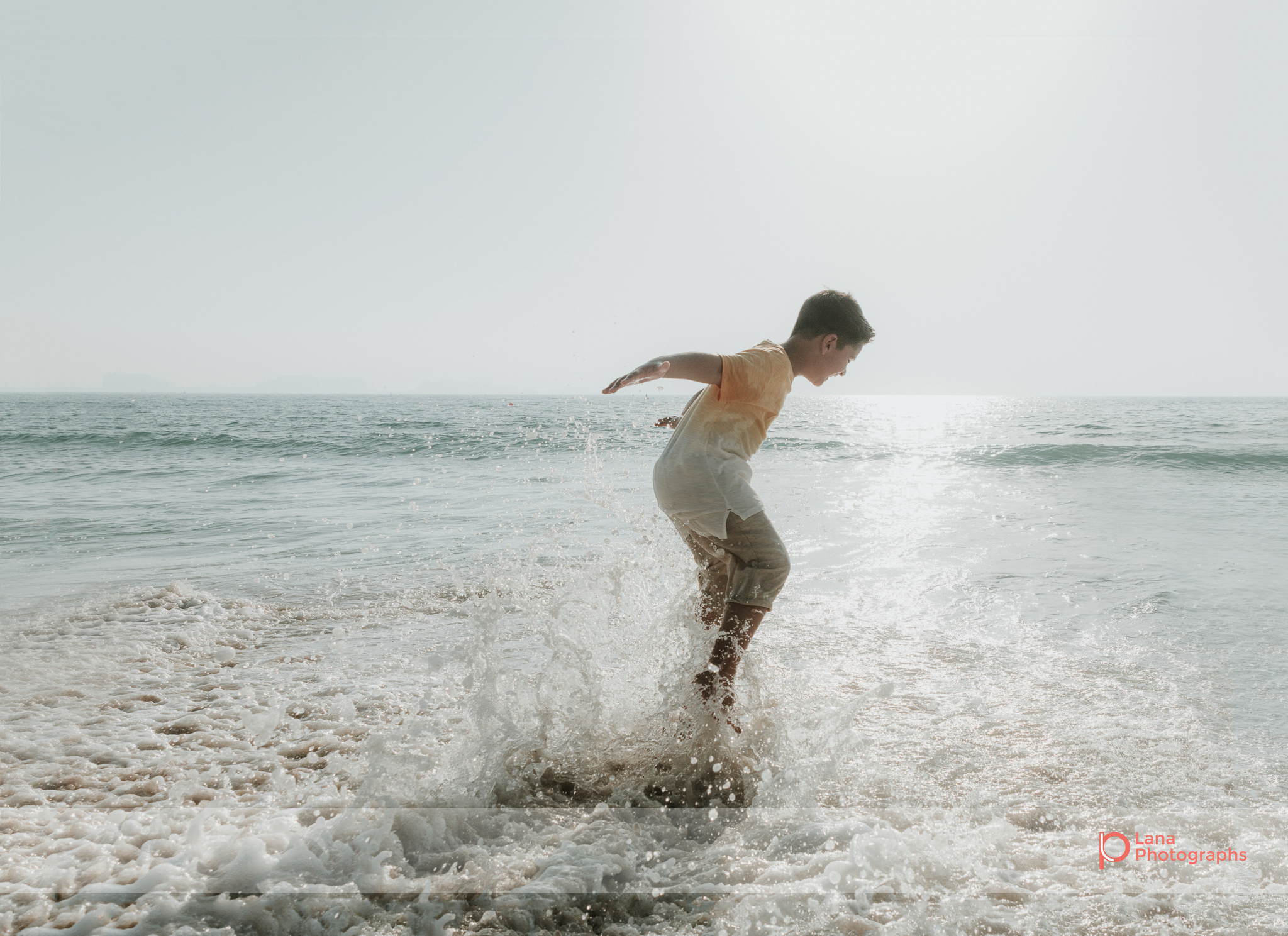  Lana Photographs Dubai Family Photography beach photoshoot young boy splashing in the water 