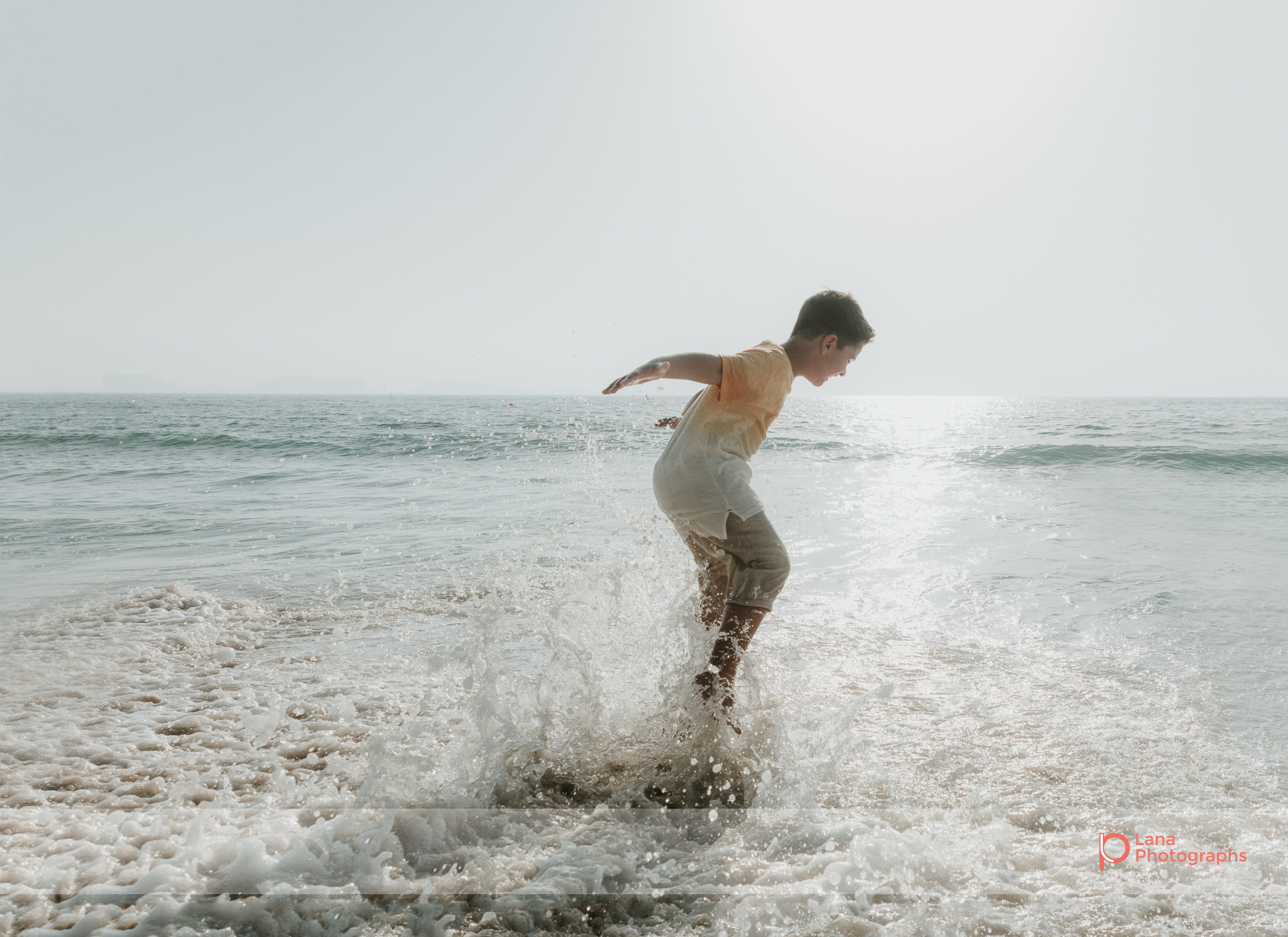 Lana Photographs Dubai Family Photography beach photoshoot young boy splashing in the water