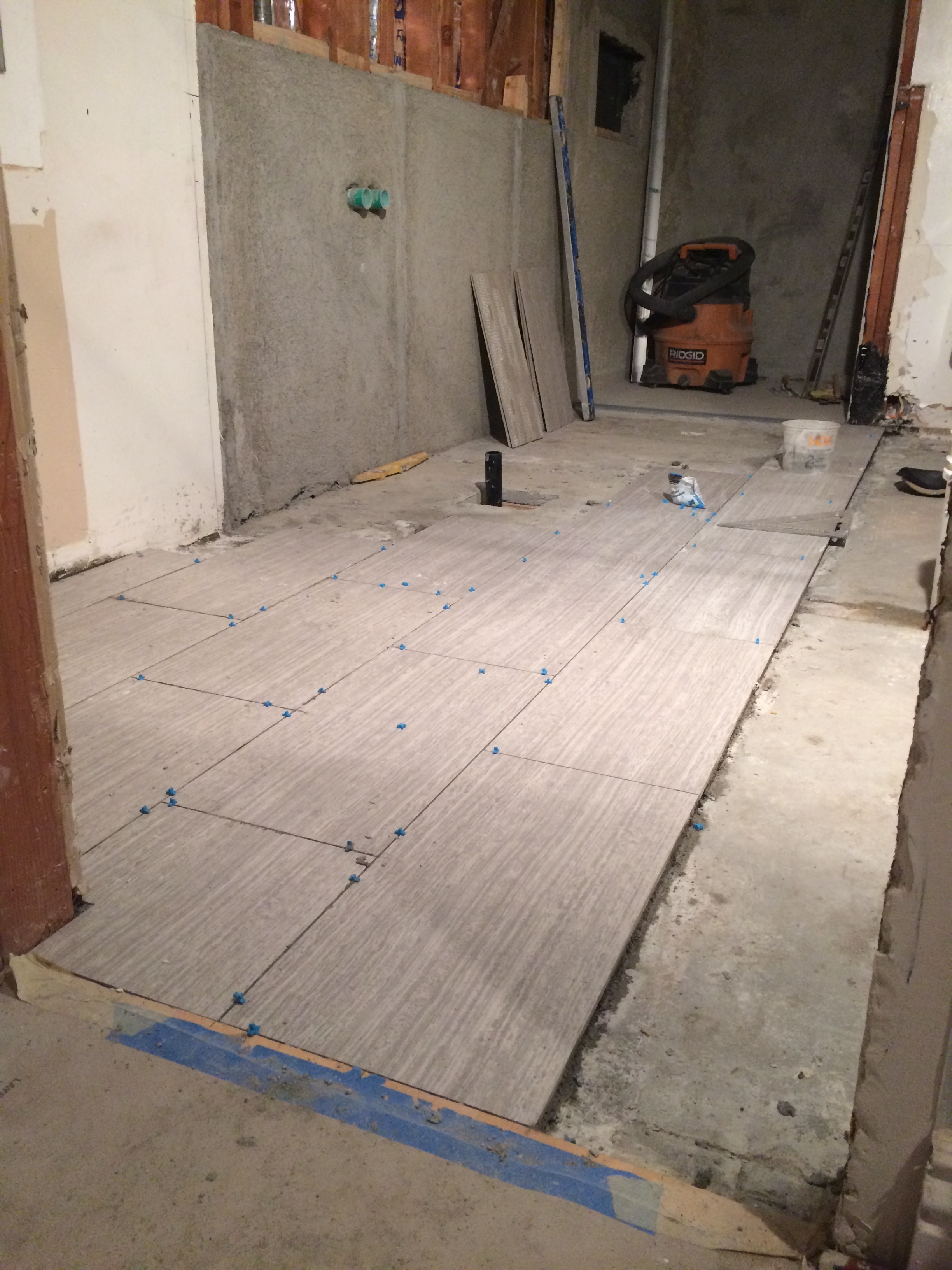 Floor tiles are halfway complete! Nice flush transition to the wood flooring at the Master Bedroom.