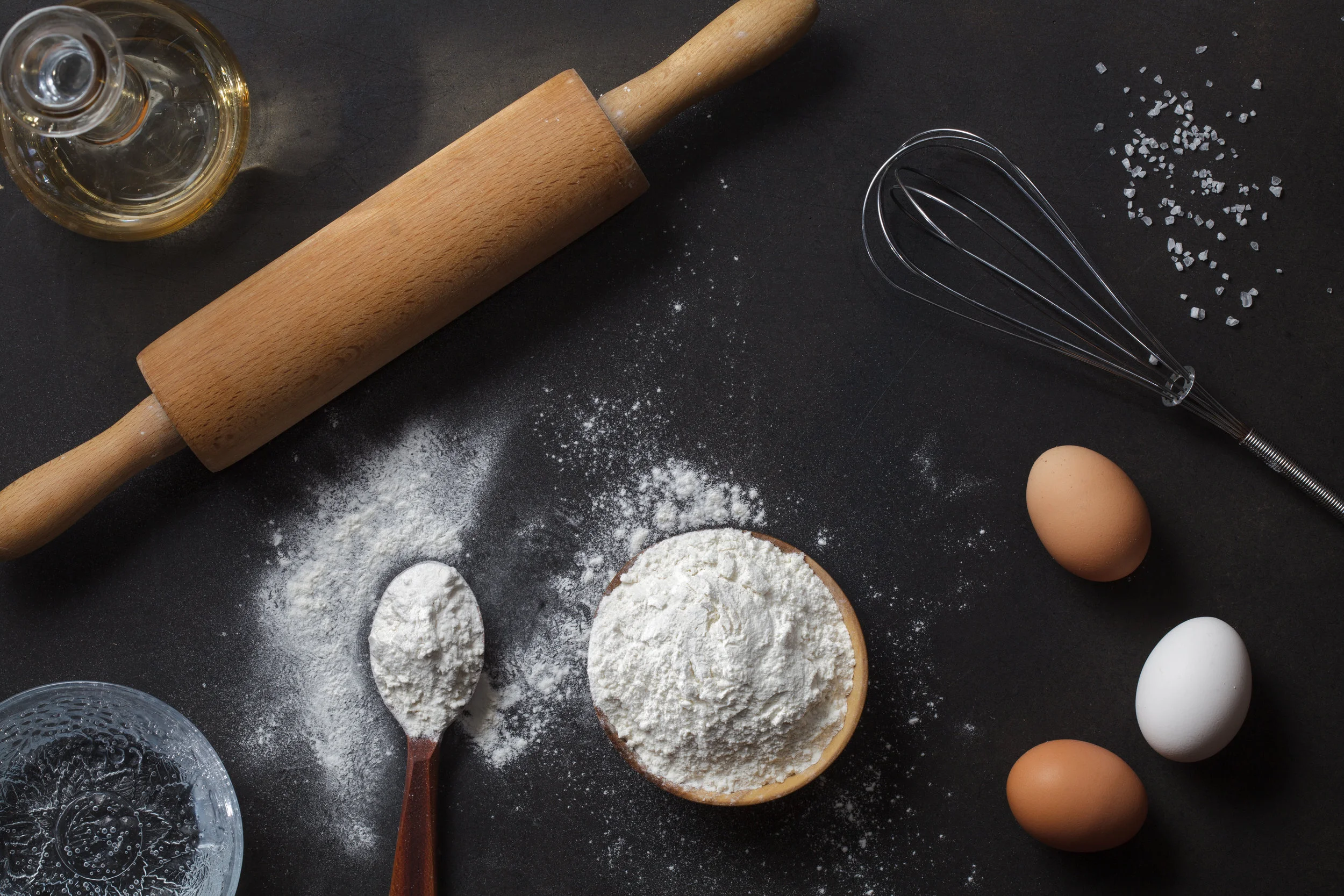 stock-photo-flour-and-ingredients-on-black-table-top-view-283115153.jpg