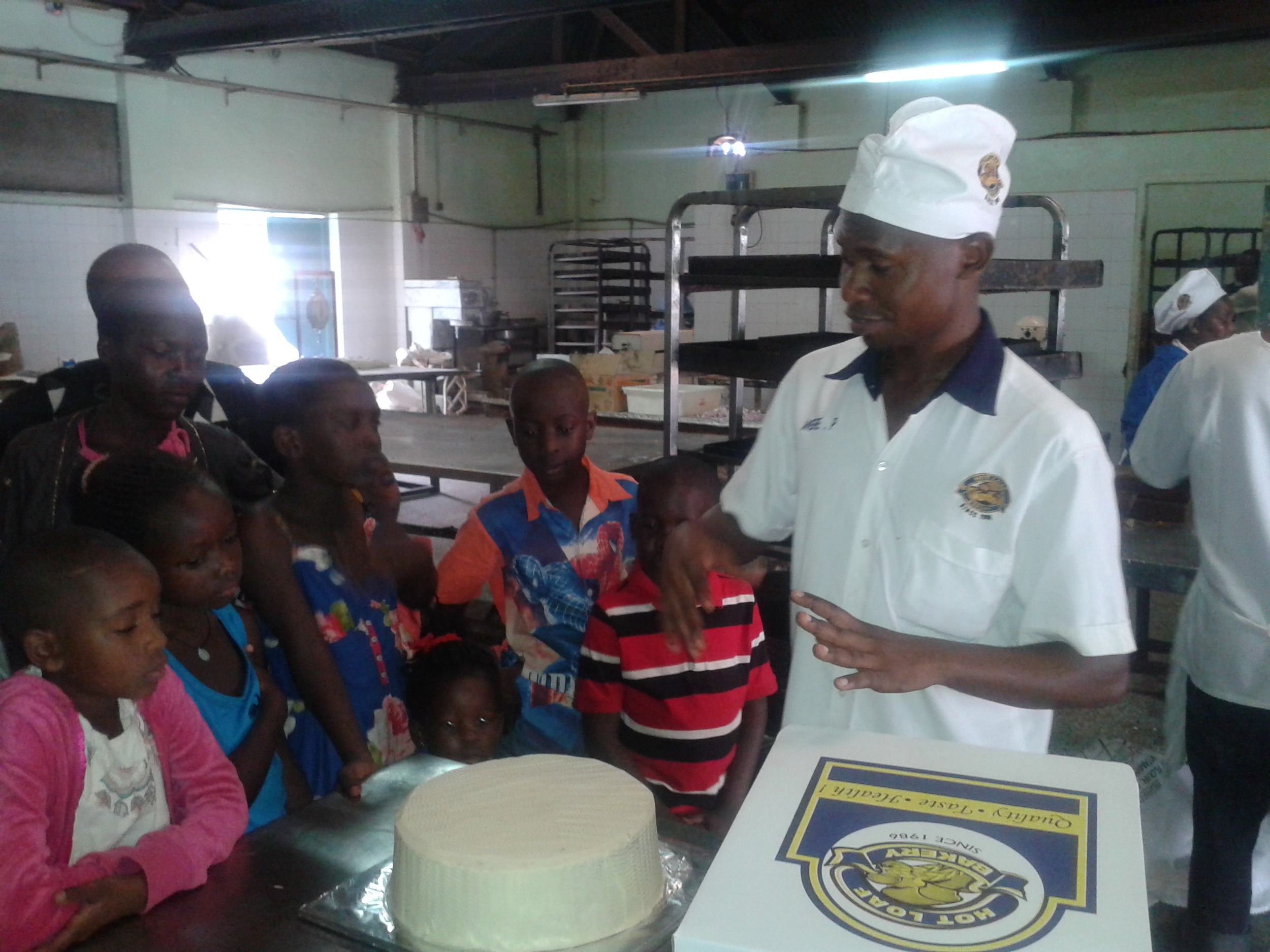 Uganda winners -Baker explains cake making at Hot Loaf Bakery .jpg