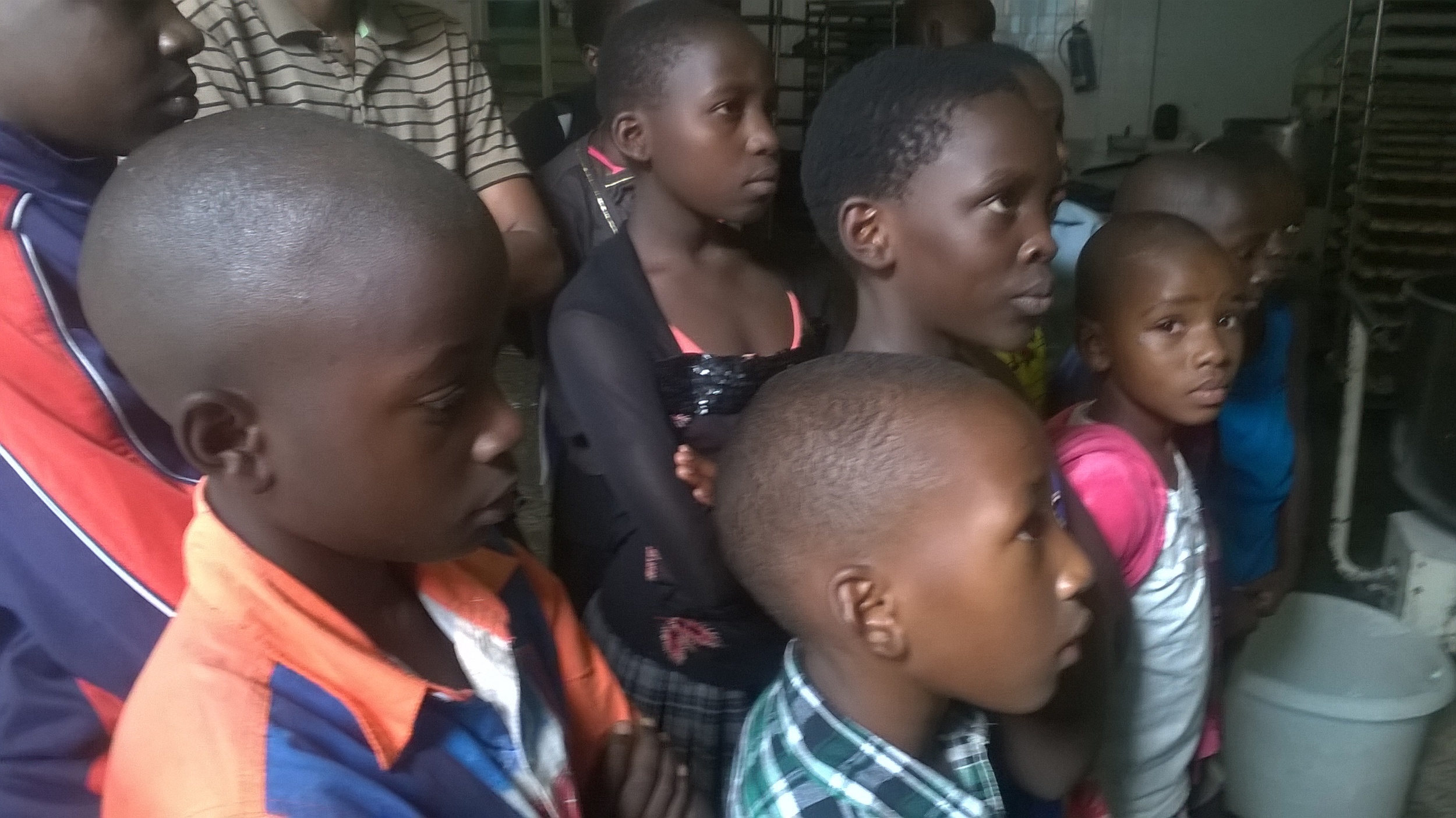 Uganda winners listen to guide at Wildlife Education Center.jpg