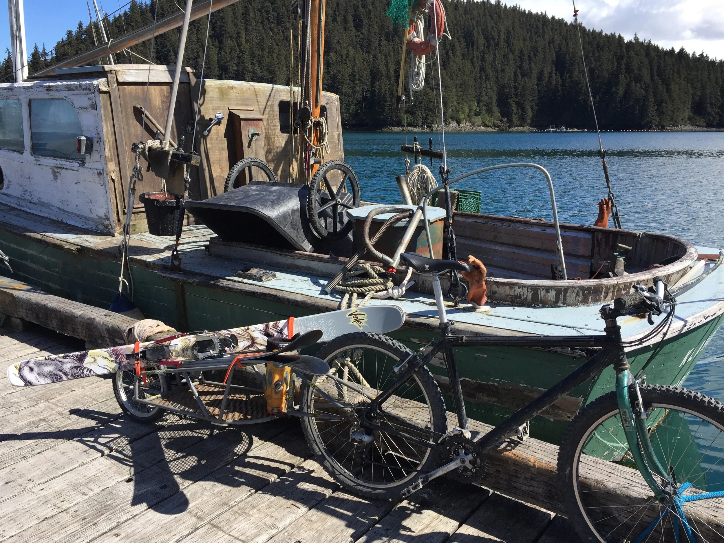 Getting ready to go skiing at the Jakolof Bay Dock next to a neat old wooden boat.