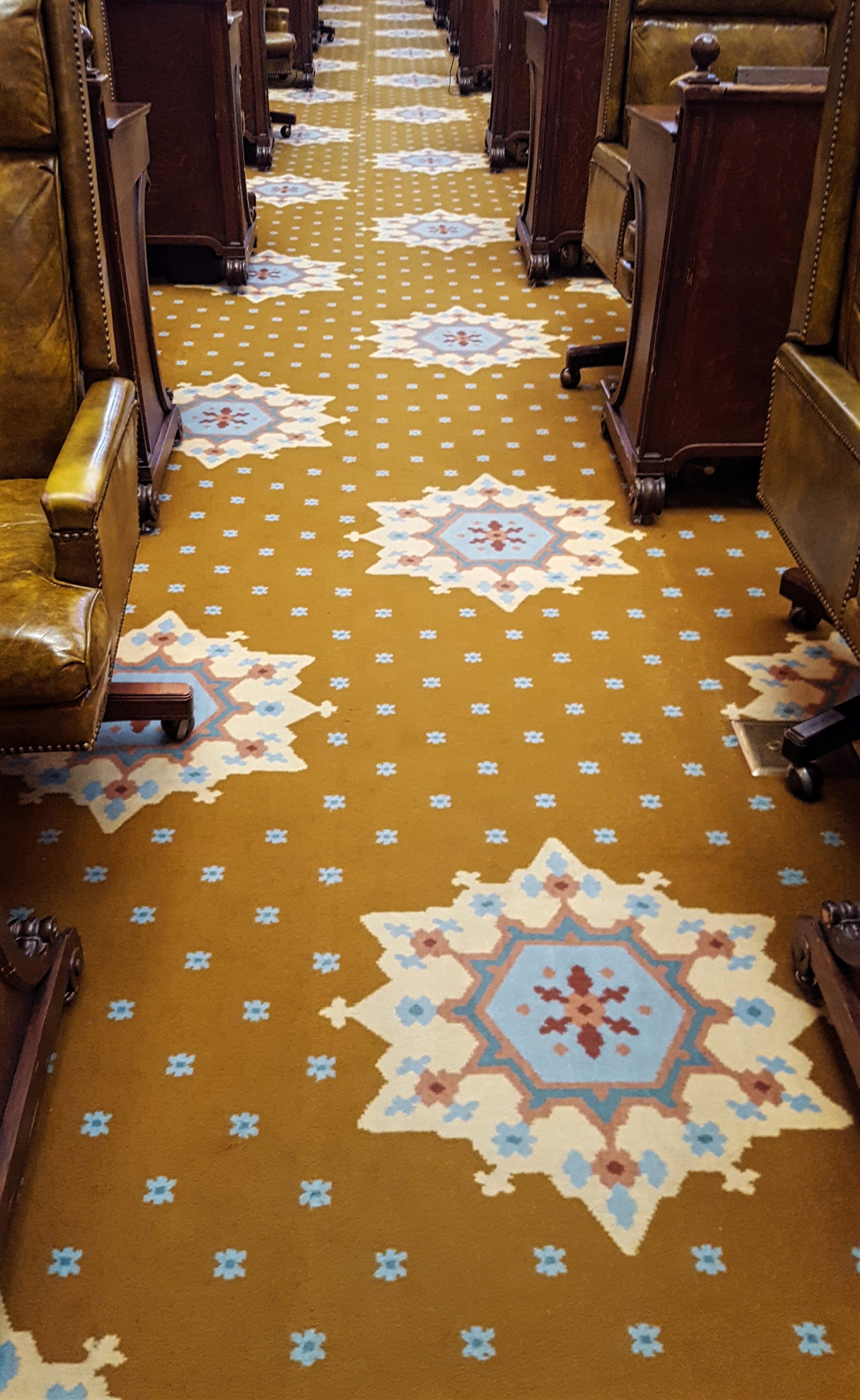 Carpet was installed to protect the tile floor; the carpet matches the tile pattern beneath
