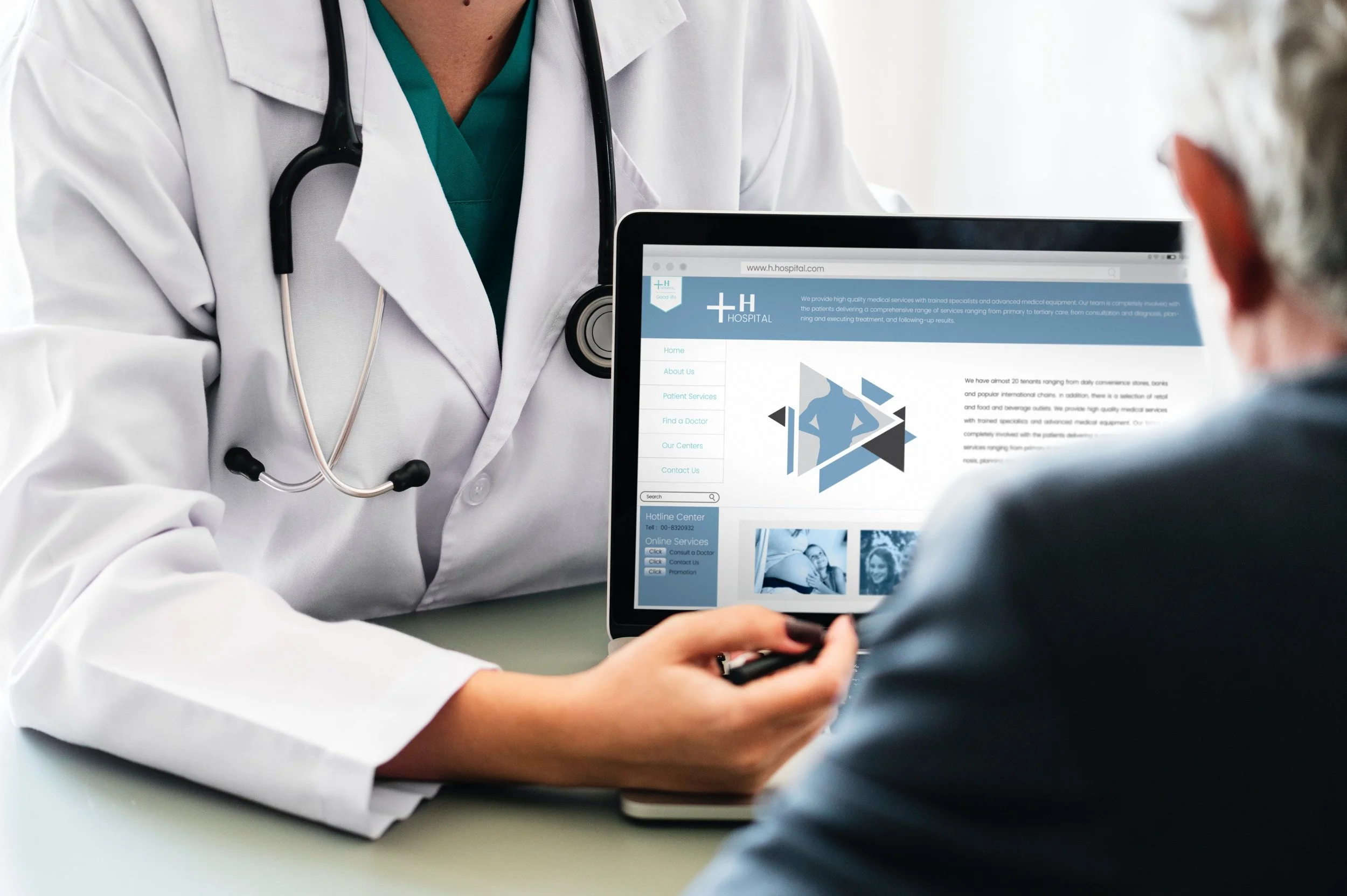 Mindful Resilience for Healthcare Professionals Image Depicting Doctor At A Desk Showing Computer Screen to a Patient
