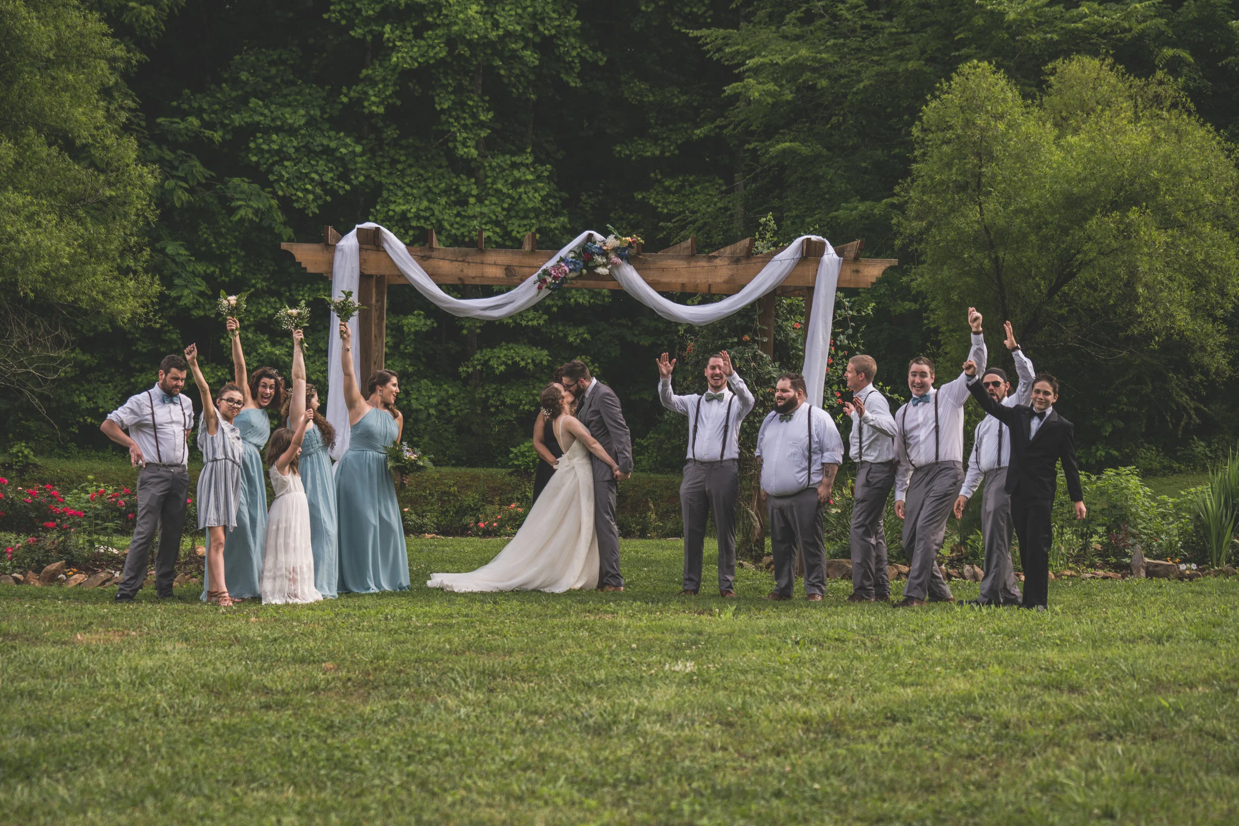 Rees wedding party celebrating at the garden arbor