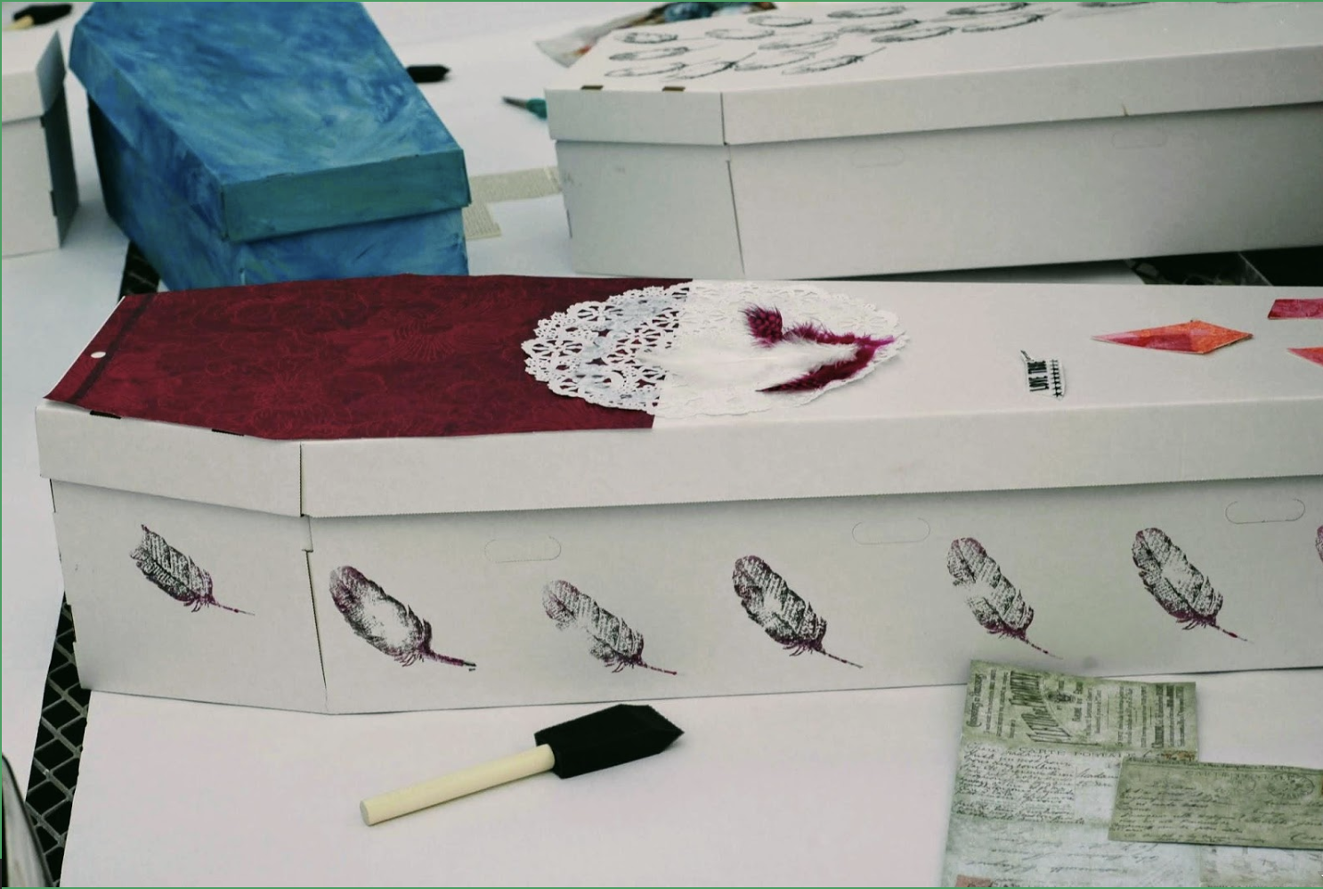 Adorning a cardboard coffin with meaningful images can be a cathartic and inspired act of grieving a loved one. Photo by Jasmine Tanguay, Natural Deathcare Collaborative