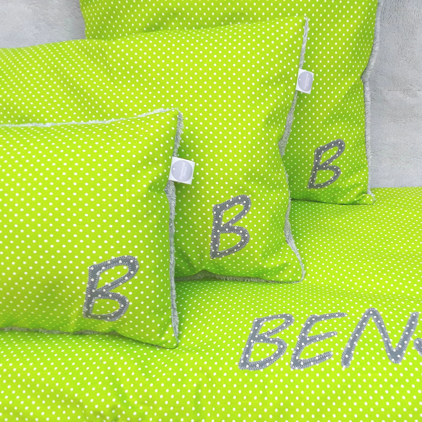 Throw cushion in Lime spot fabric and fleece back.