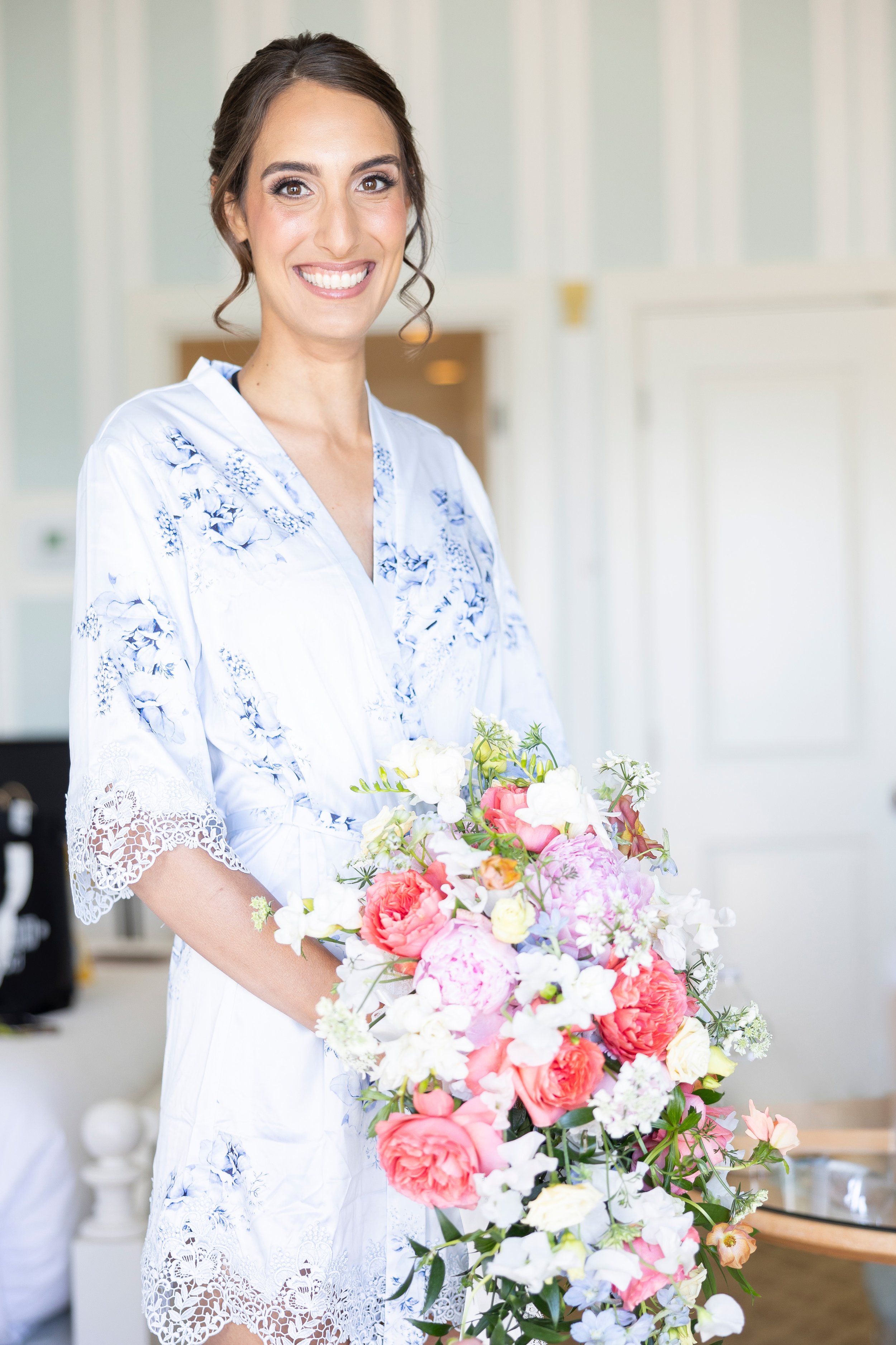 cape cod wedding wequassett bride in robe with bouqet getting ready