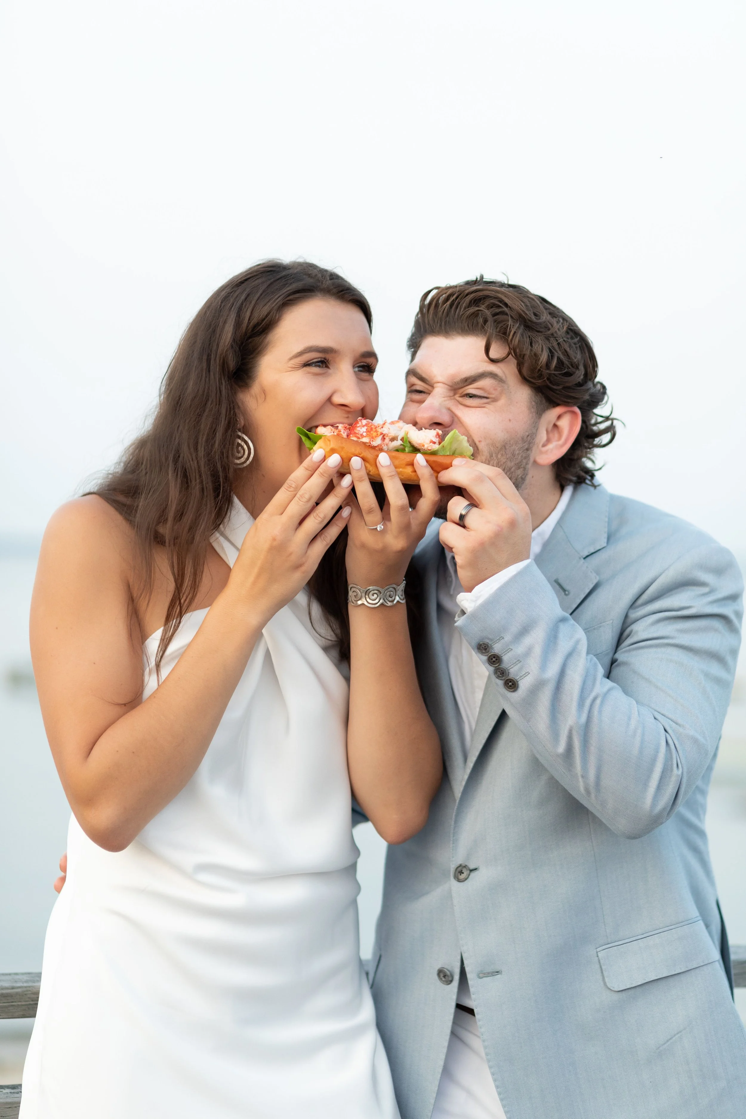 cape cod wedding welcome party couple eating lobster roll.jpg