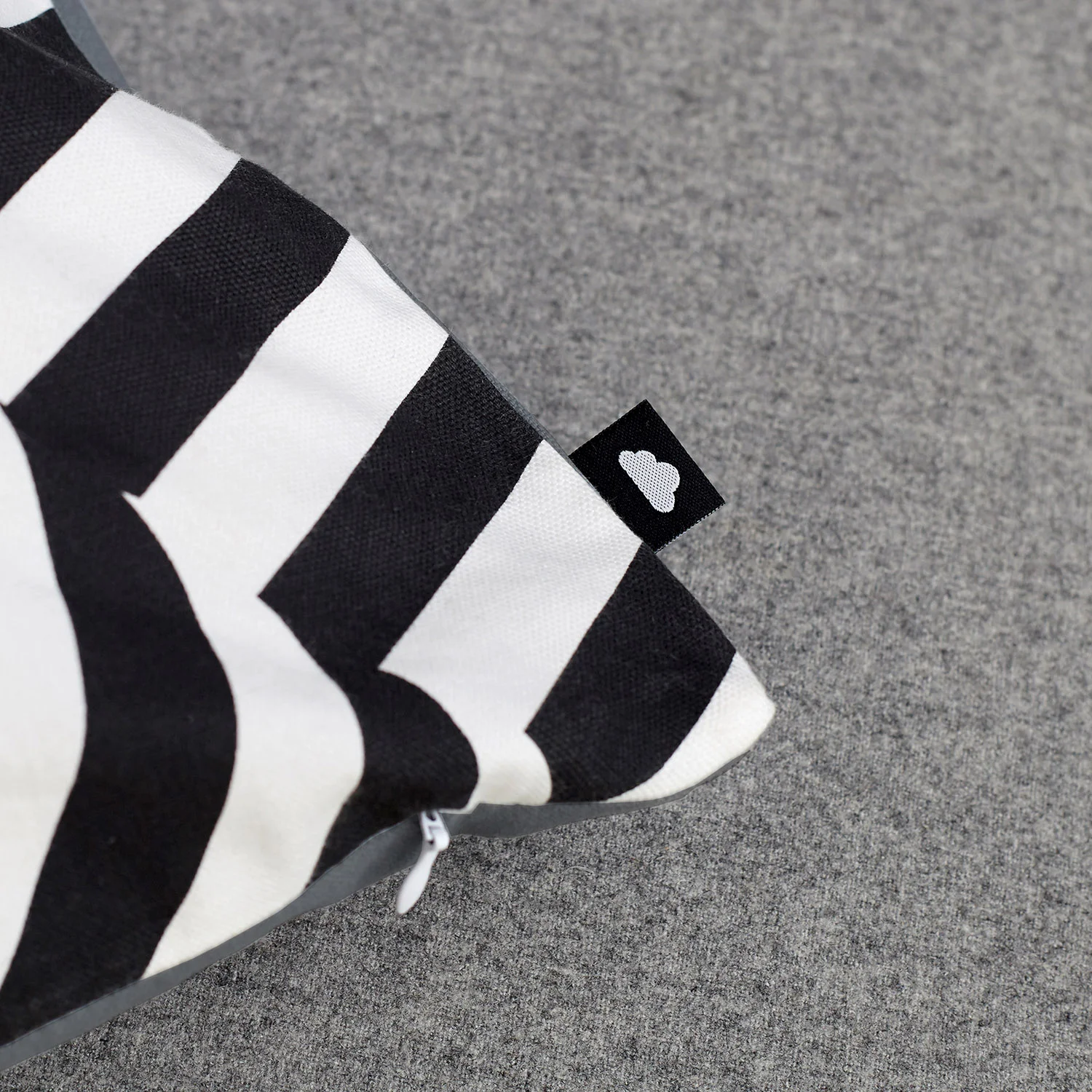 Monochrome striped cushion, showing the graphic crumpled piece of striped fabric, creating an optical illusion