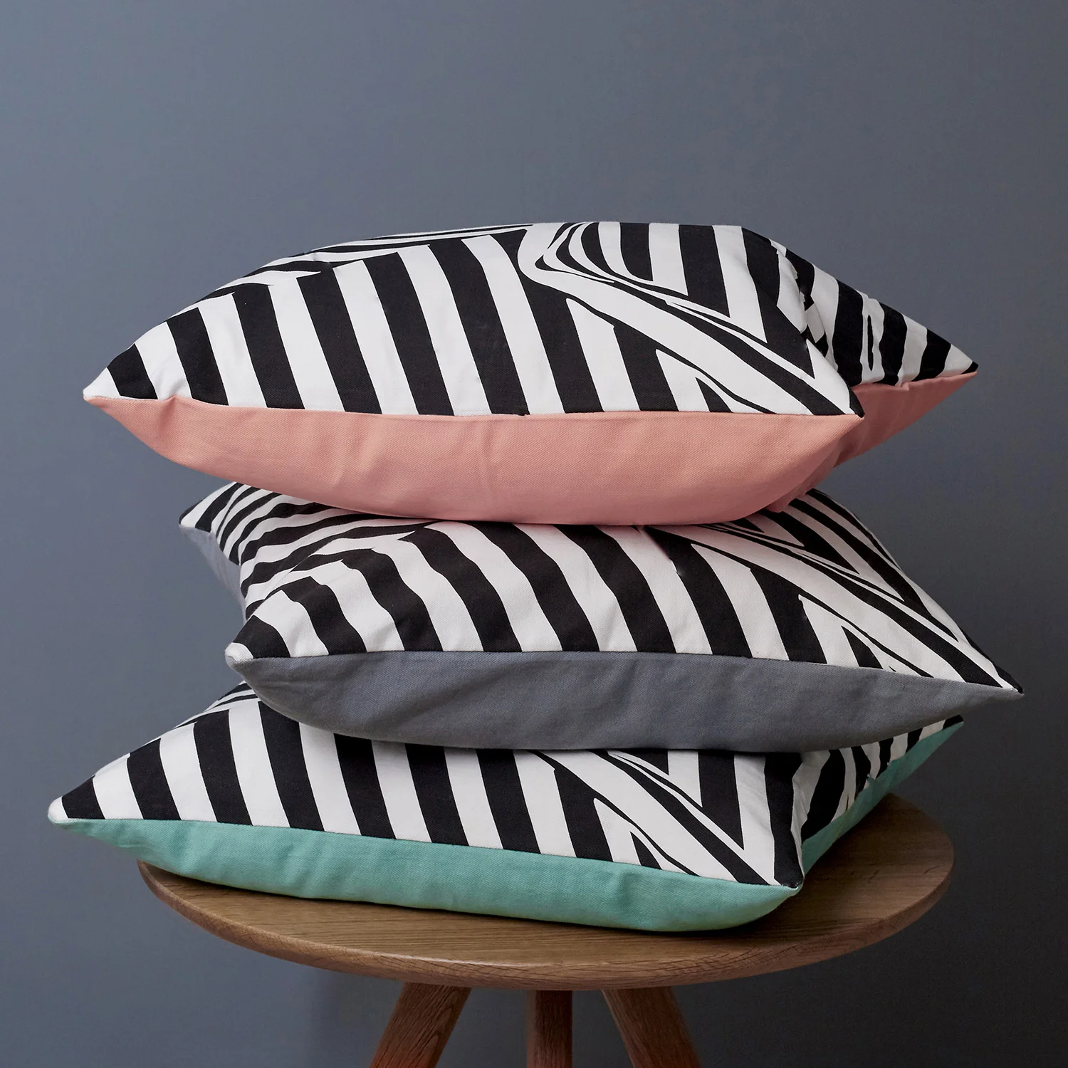 Monochrome striped cushion, showing the graphic crumpled piece of striped fabric, creating an optical illusion
