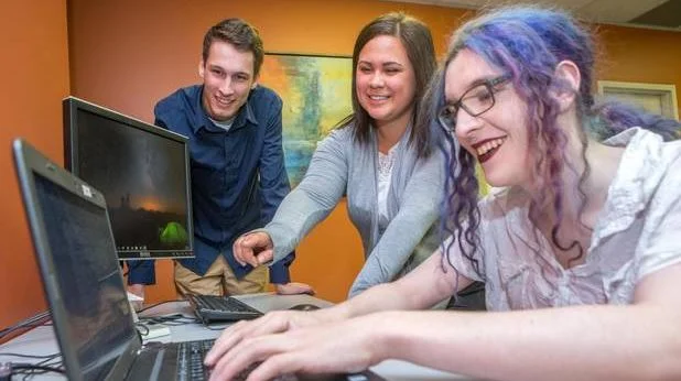 From left: Devin Brooks, Shawnee Polchis-Lanteigne and Indigo Poirier work on a project at the offices of PQA Testing in Fredericton, NB. (James West/The Globe and Mail)