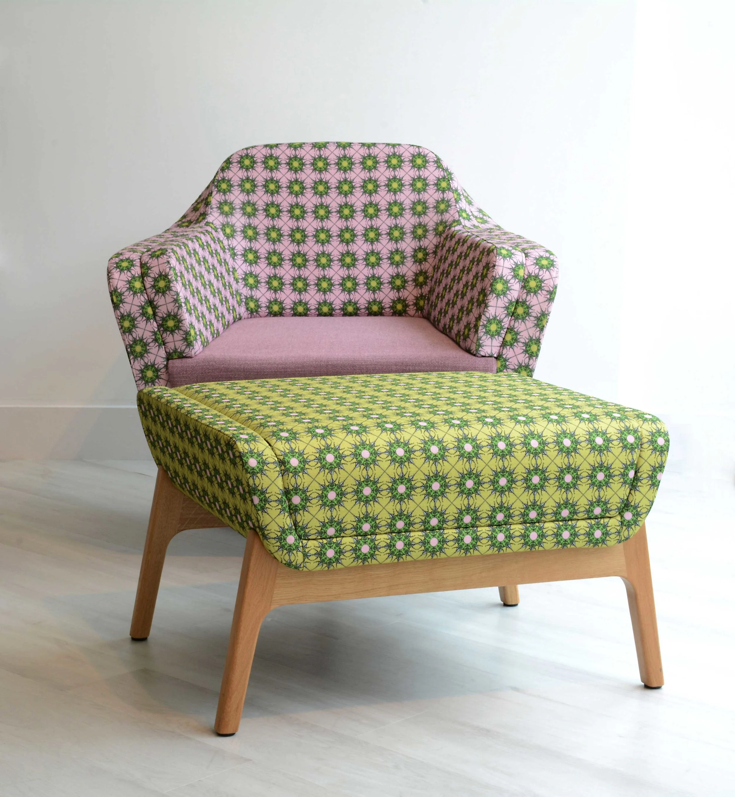 The Harc tub chair upholstered in Petra Parker 016 with footstool in Percy Parker 015