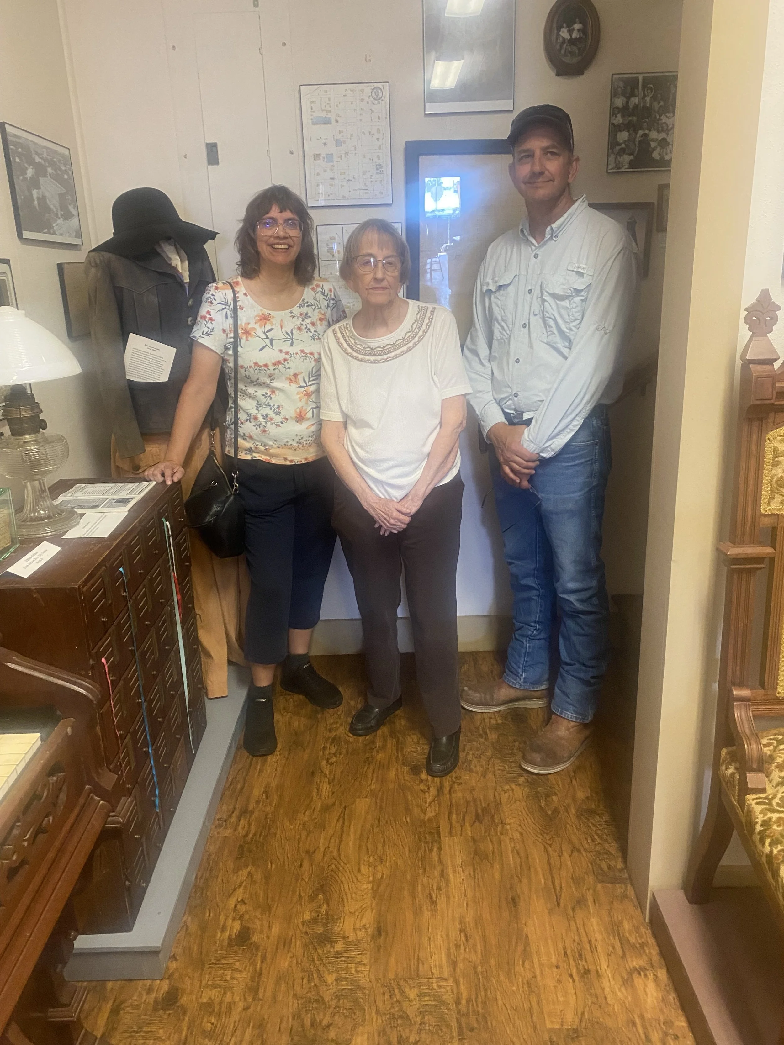 Meador family by ribbon cabinet from the old Meador store.
