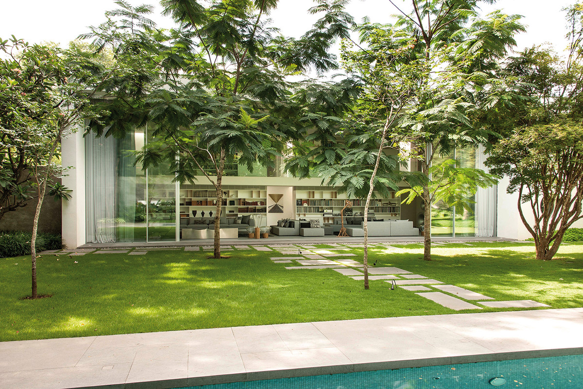 SAO PAULO, BRAZIL - The two-story concrete house, is home to a music studio. A secluded patio with lounge furniture situated between the kitchen and service areas while the owners enjoy representative living in a spacious area with an adjoining library.