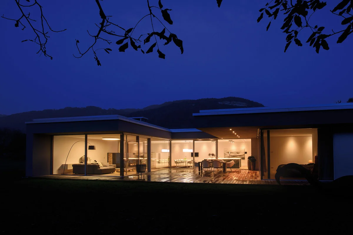 GÖFIS, AUSTRIA - the striking recess in the rear façade overlooking the garden provides plenty of space for a spacious veranda. This is protected by the roof that projects from the side. The living room, cooking and dining areas merge with one another and are arranged around the terrace.