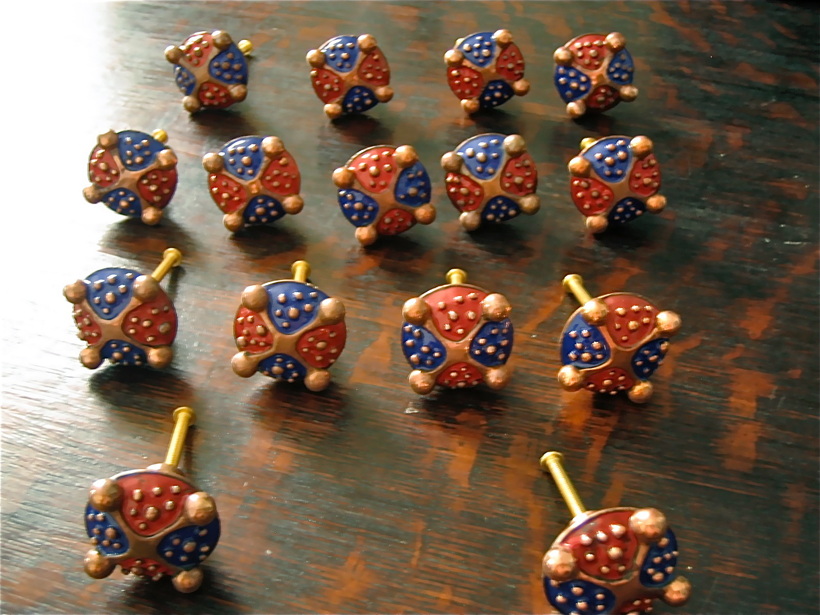 Custom door pulls of copper and enamel