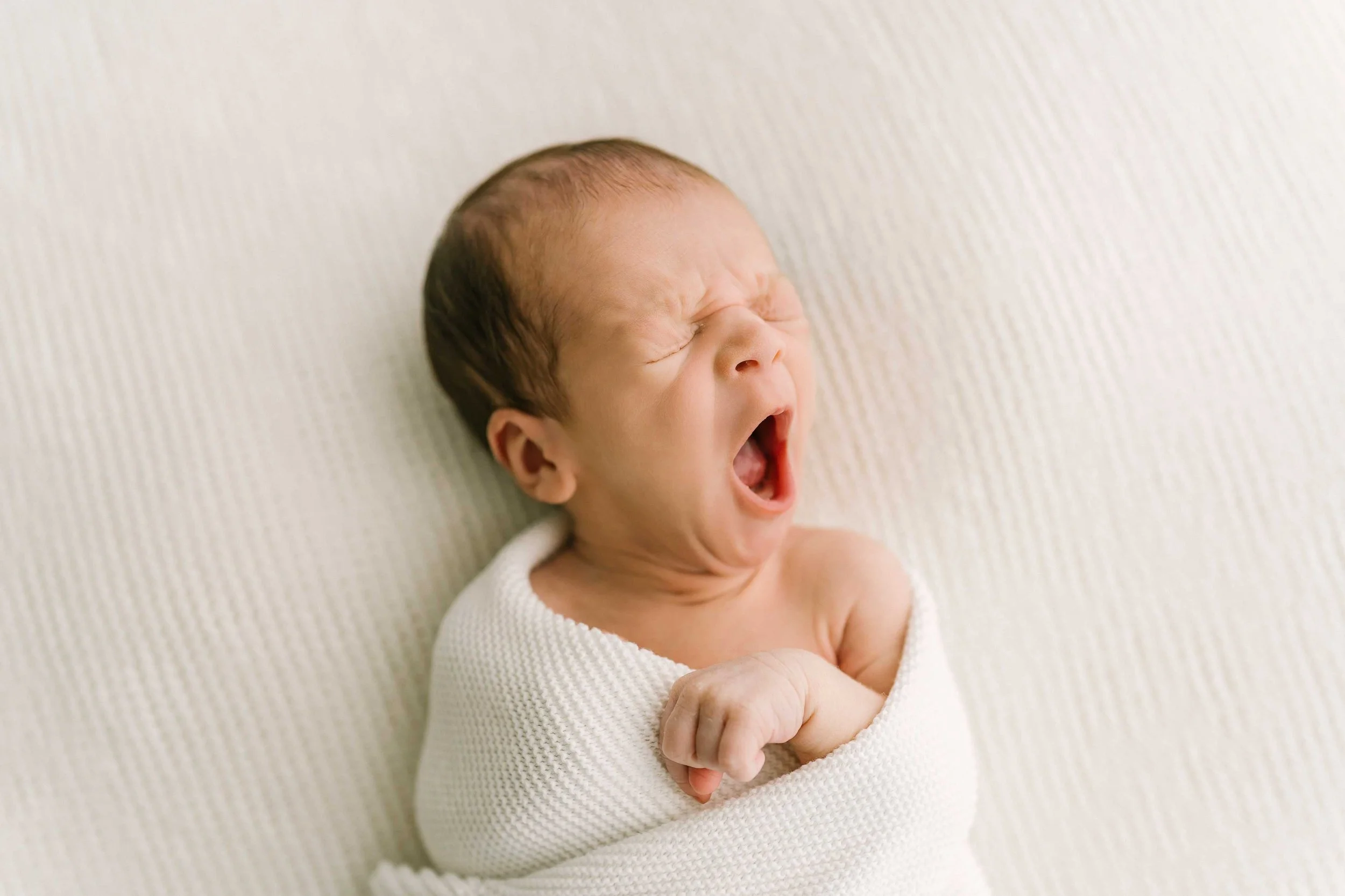 Chong newborn baby yawning during a Niagara newborn photography session