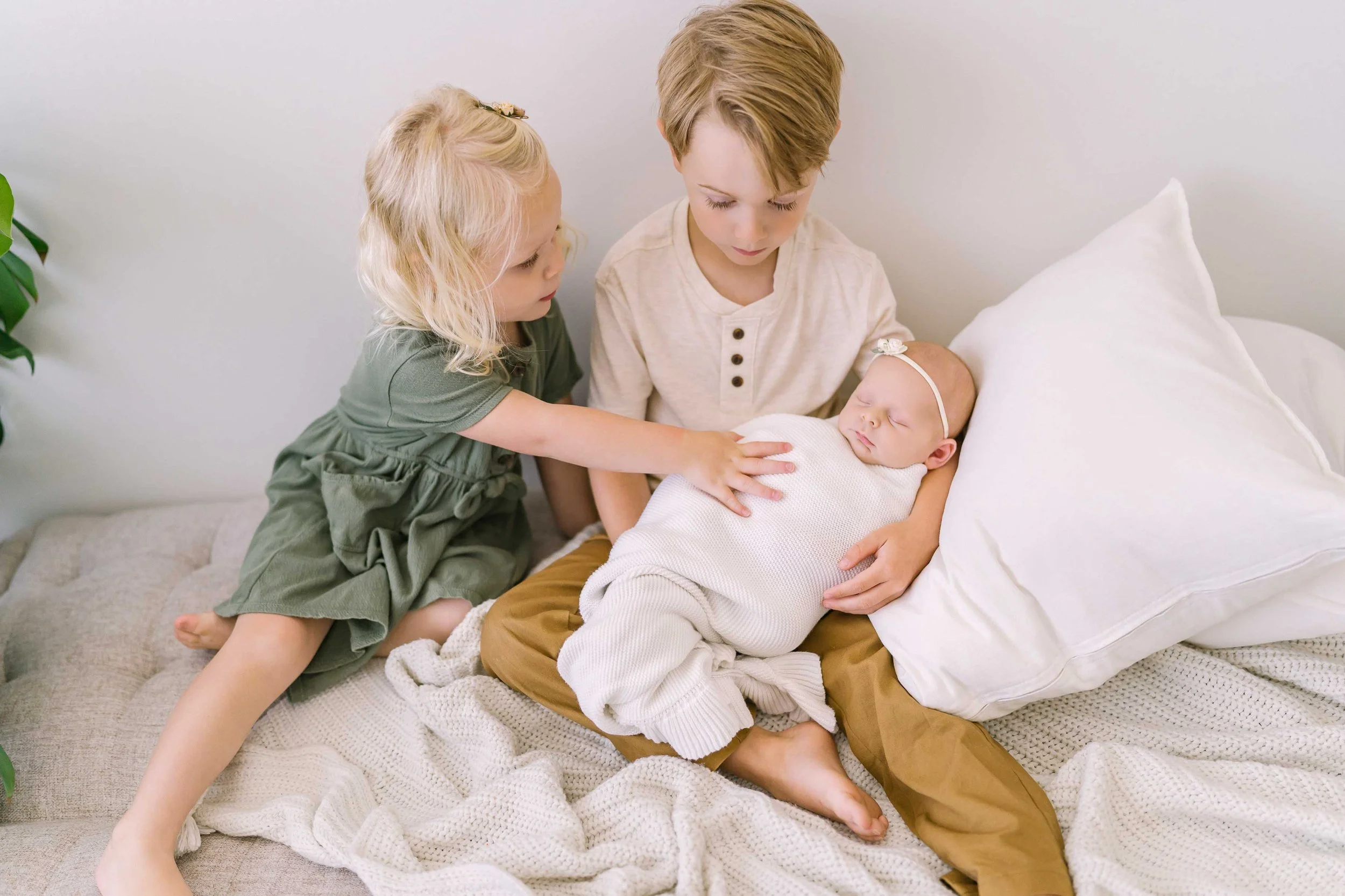 Lupia big brother holding his newborn baby sister during a Grimsby photo session
