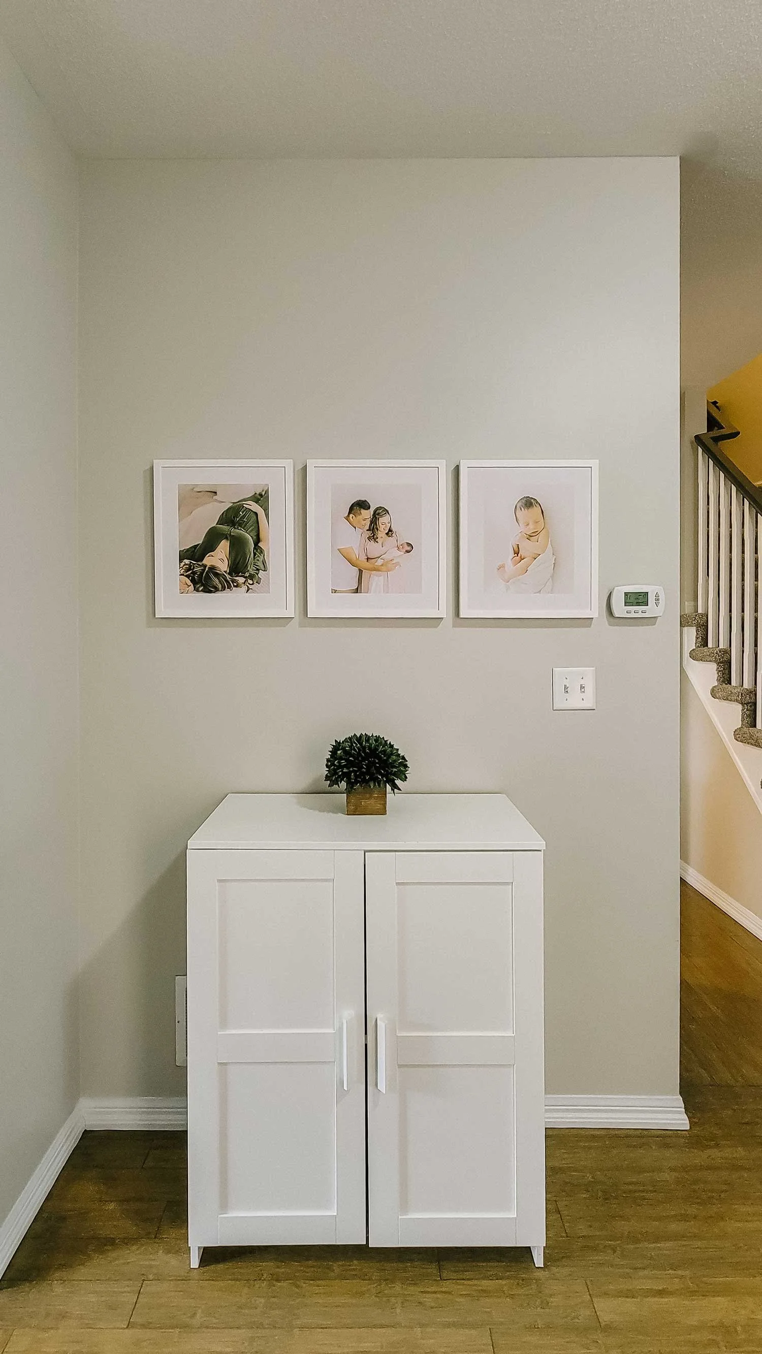 Finished framed gallery wall installation from heirloom newborn photo albums Niagara collection