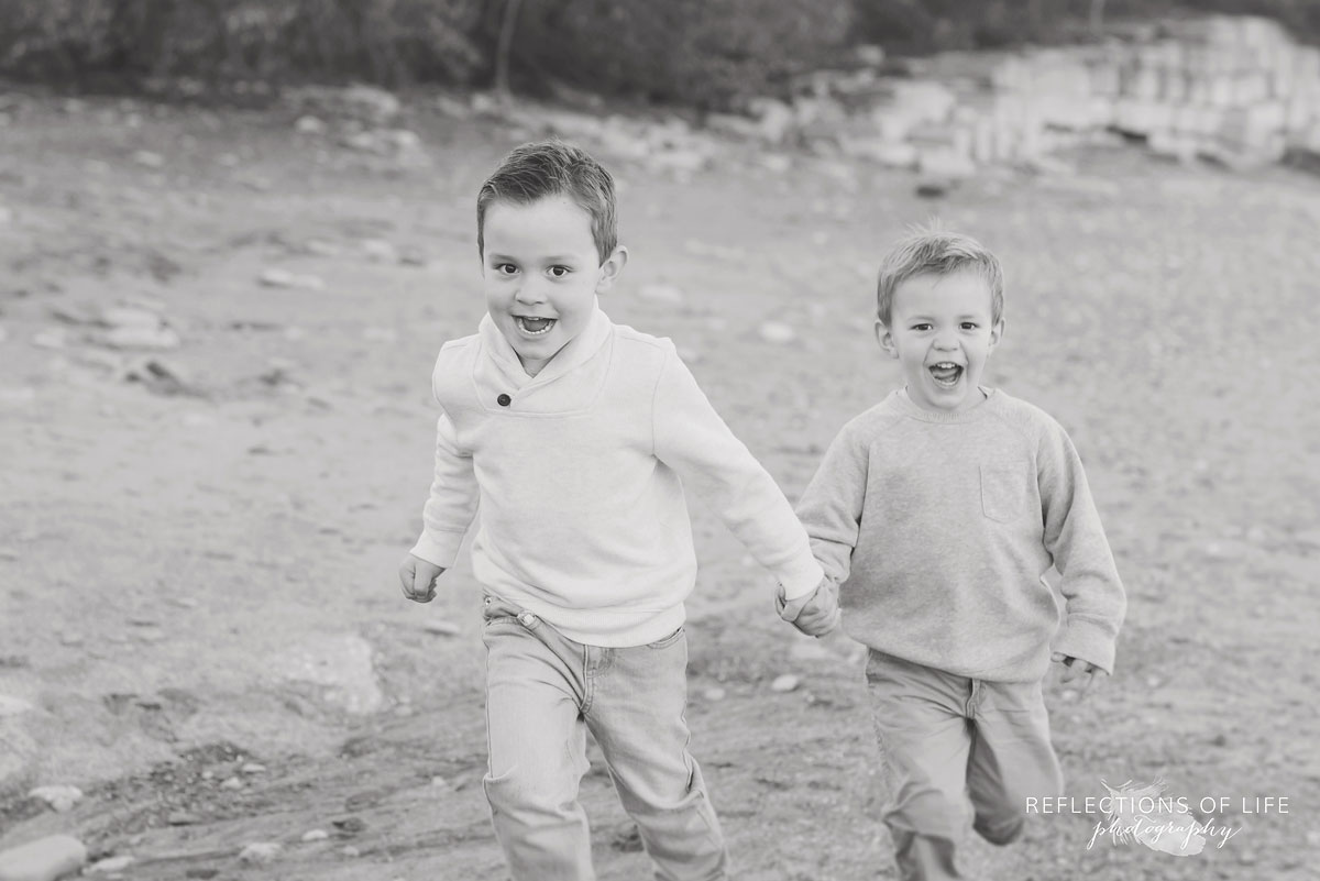 little boys running on the beach in niagara region of ontario canada