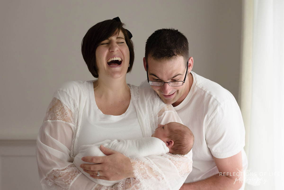 014 Professional Toronto Family and Newborn Photos Mom laughing holding baby