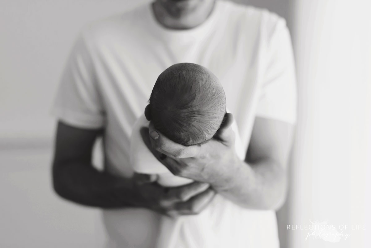 016 Newborn baby is daddy's hands Niagara Region Newborn Photography