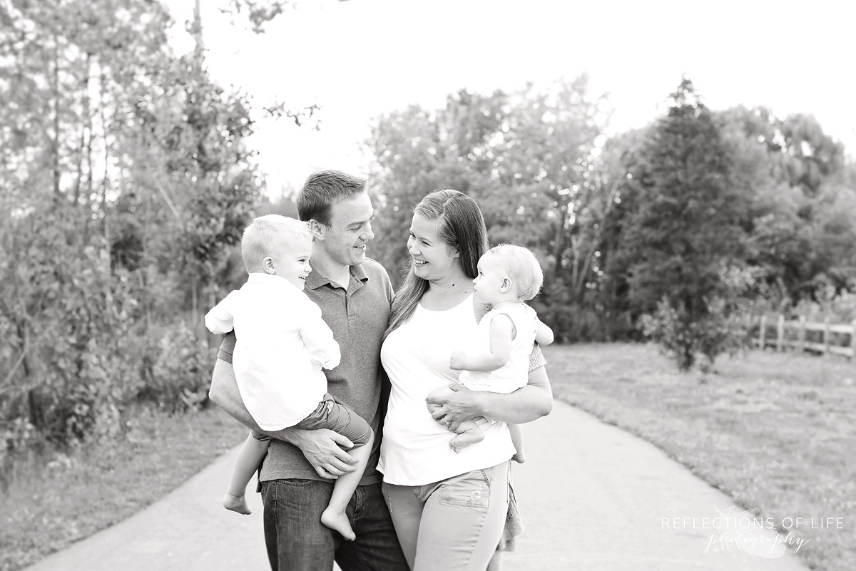 004 Niagara Family Photographer Mom Dad and Kids on a path in the park