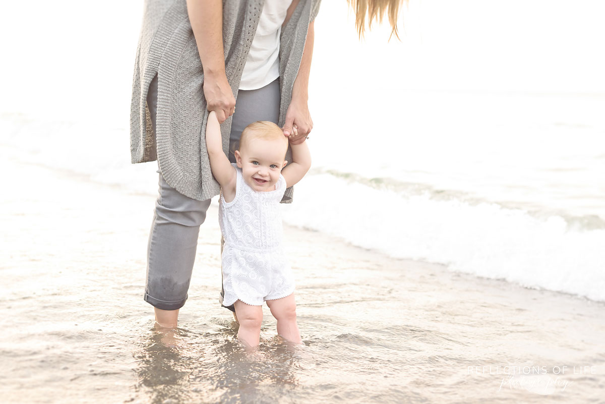 018 Adorable baby girl portrait on the beach in the water