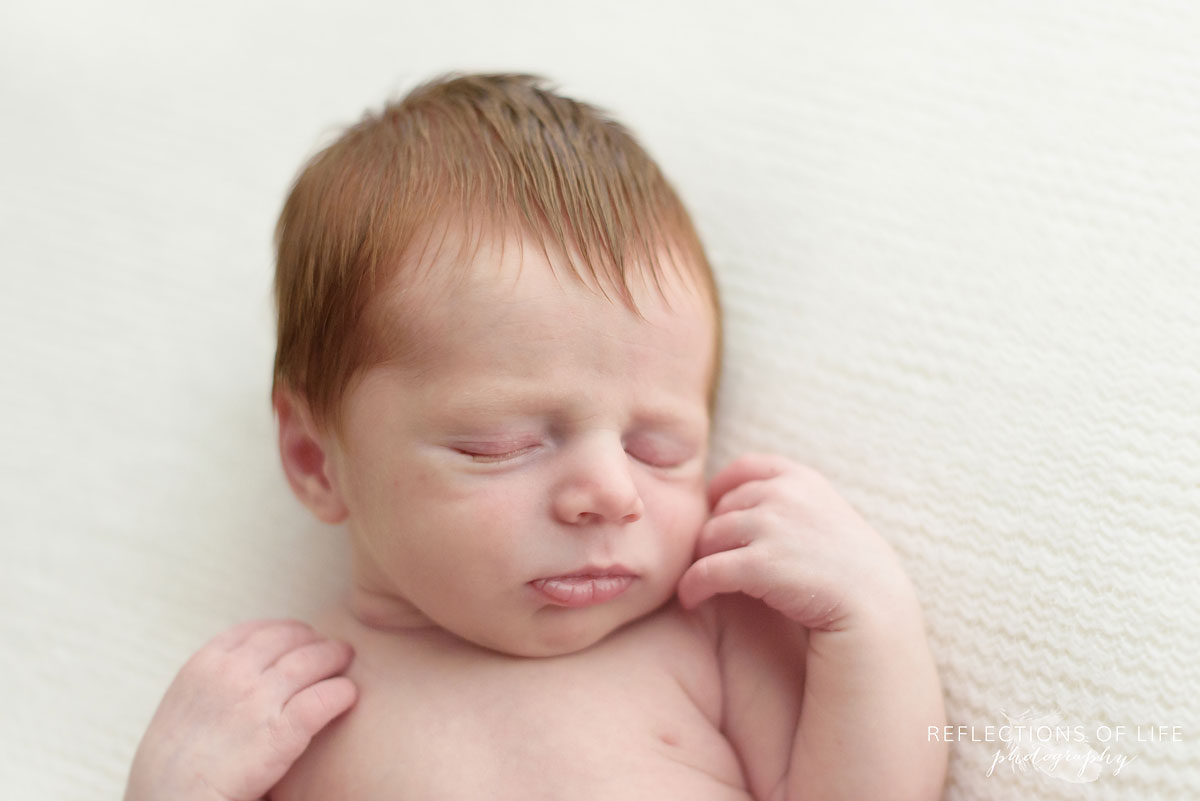 023 professional newborn baby photography of redhead baby boy