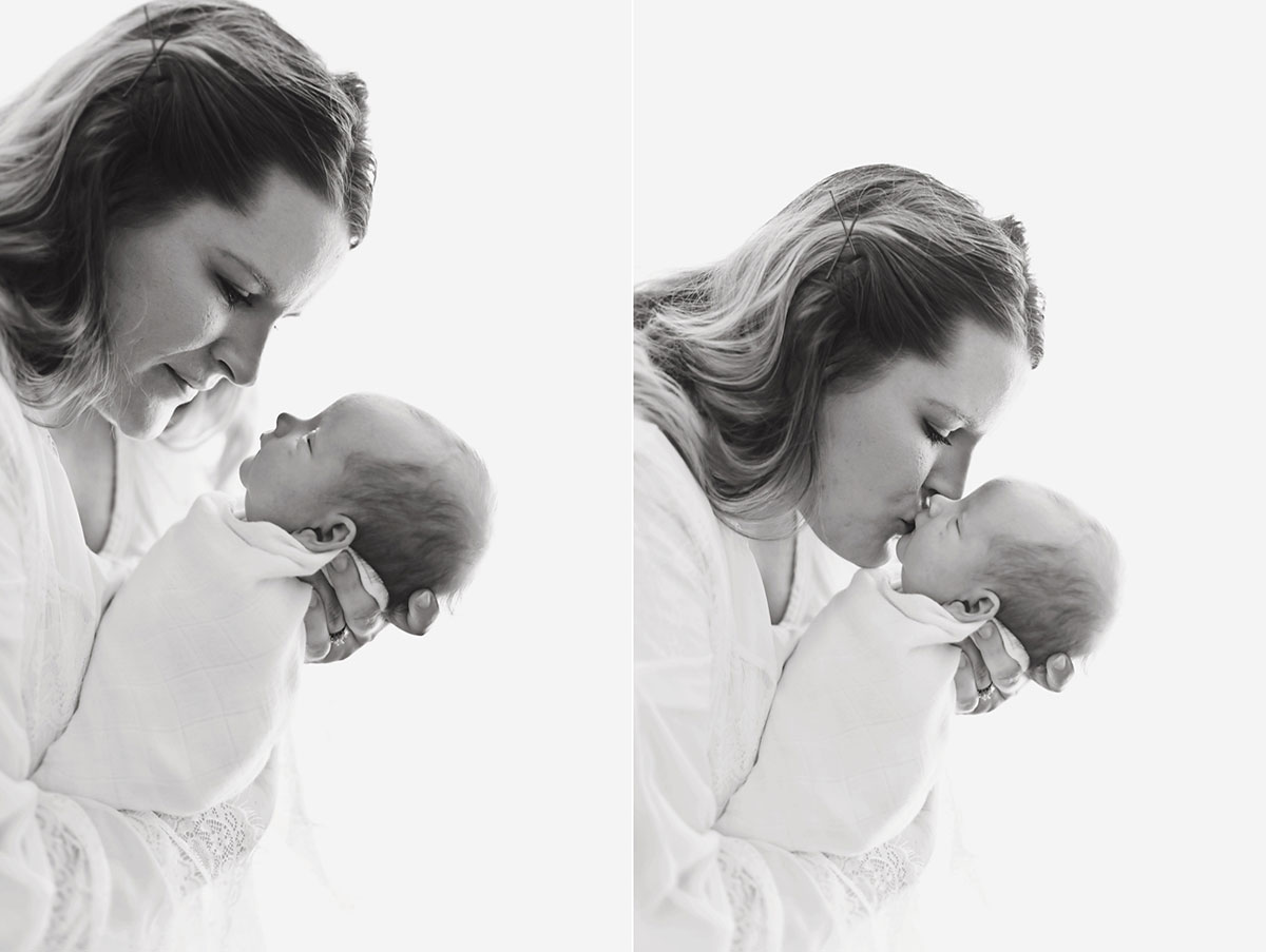 black and white image of mommy leaning down and kissing her newborn baby boy 014
