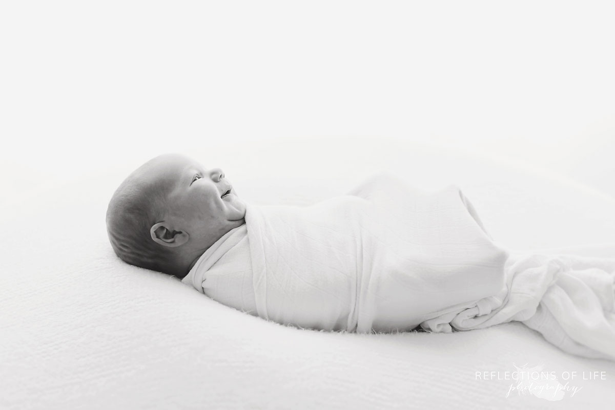 Toronto Newborn Portrait of baby swaddled in white
