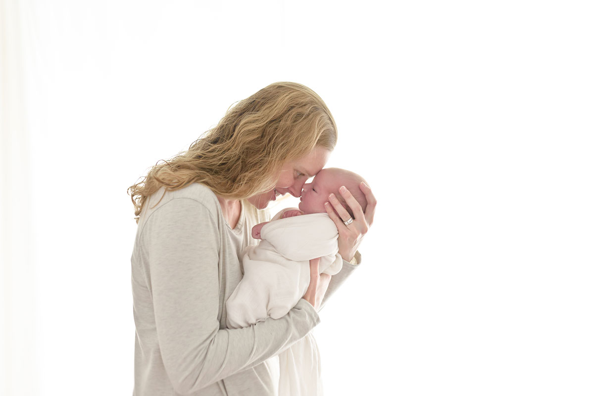 Mom totally in love with her newborn baby son in Niagara newborn photo studio