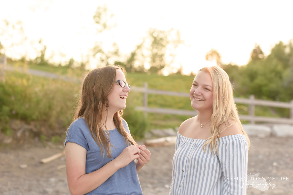 Sisters laughing on the beach near Lake Ontario