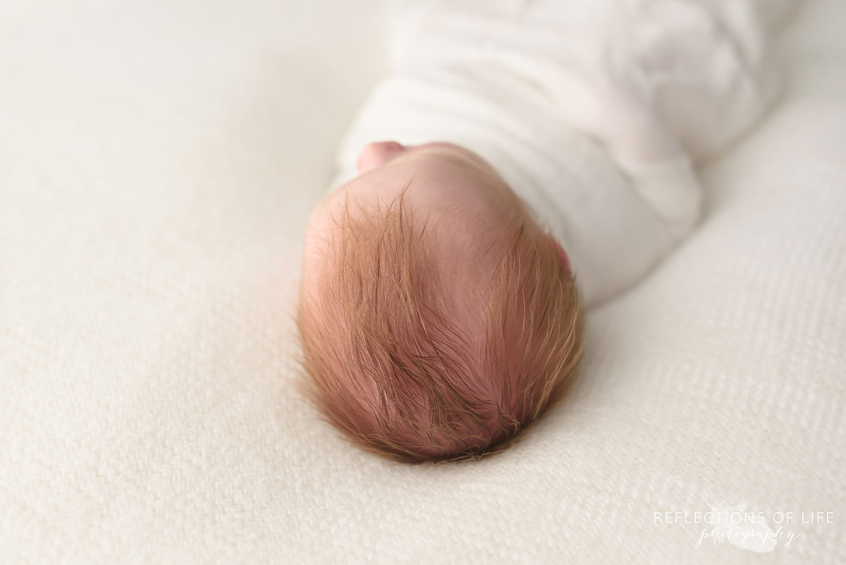 Professional newborn baby boy studio image of redhead