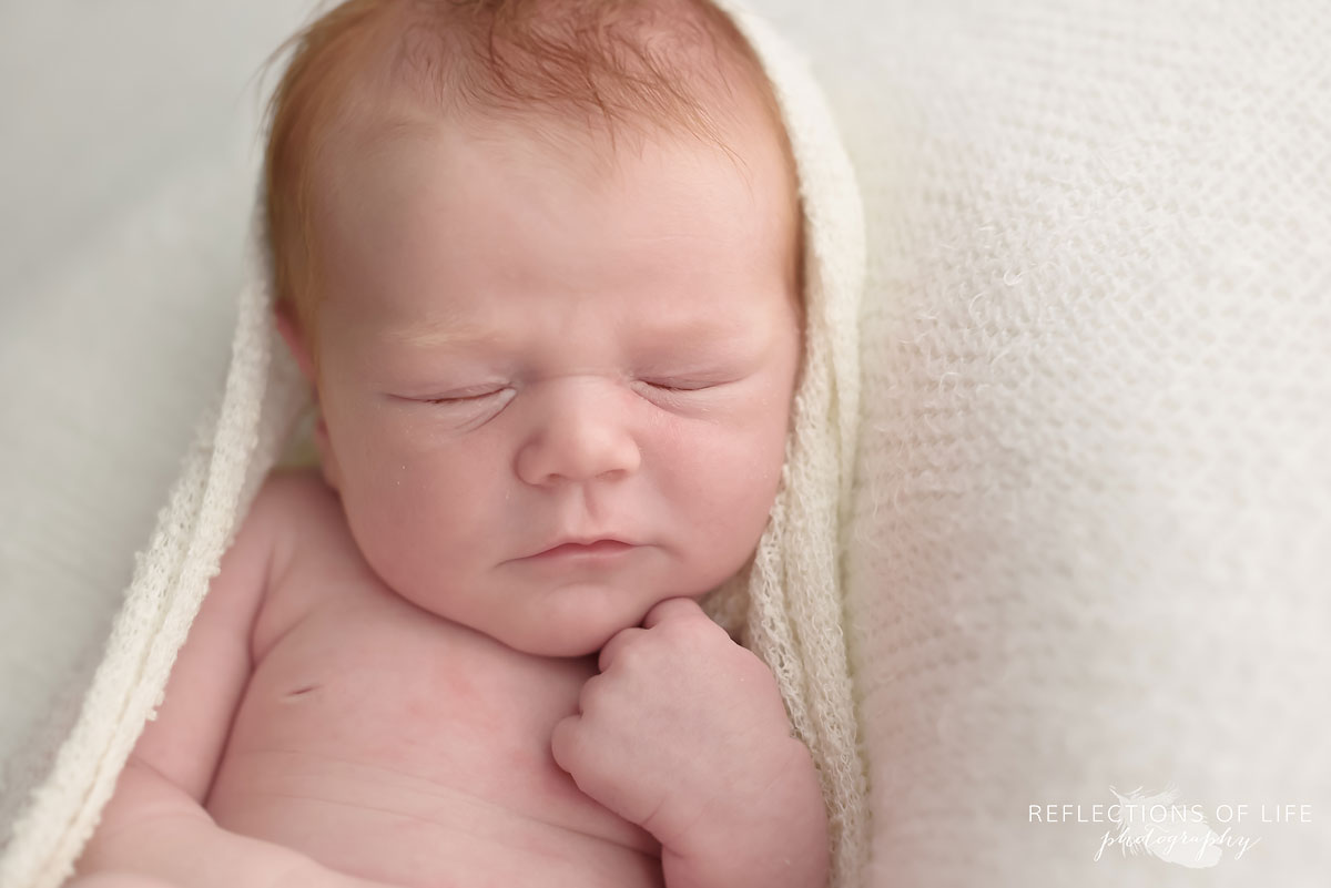 Niagara newborn photo studio redhead baby relaxing