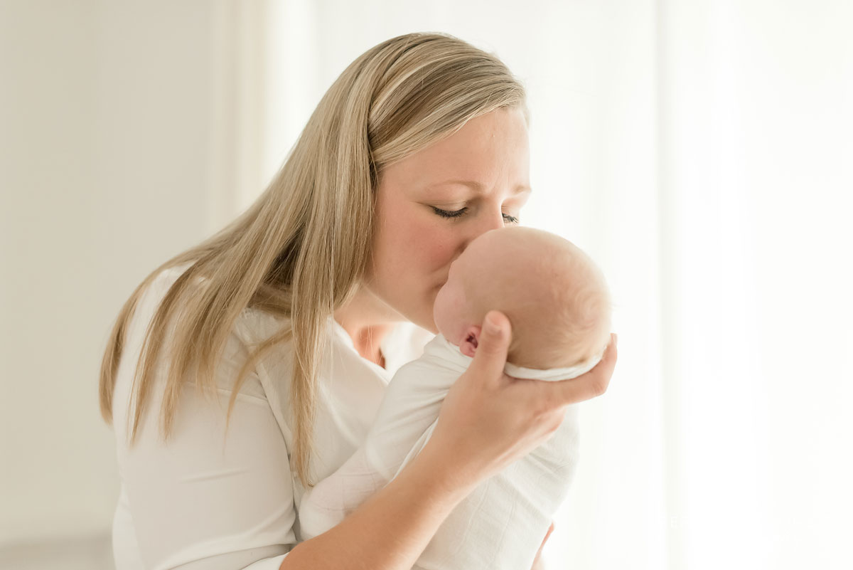 Mom kissing baby boy Professional Niagara Newborn Photos