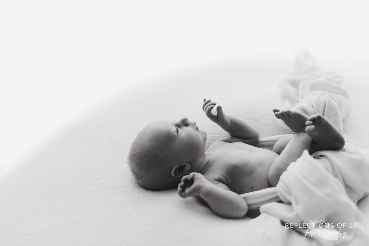 Black and white image of baby in natural light