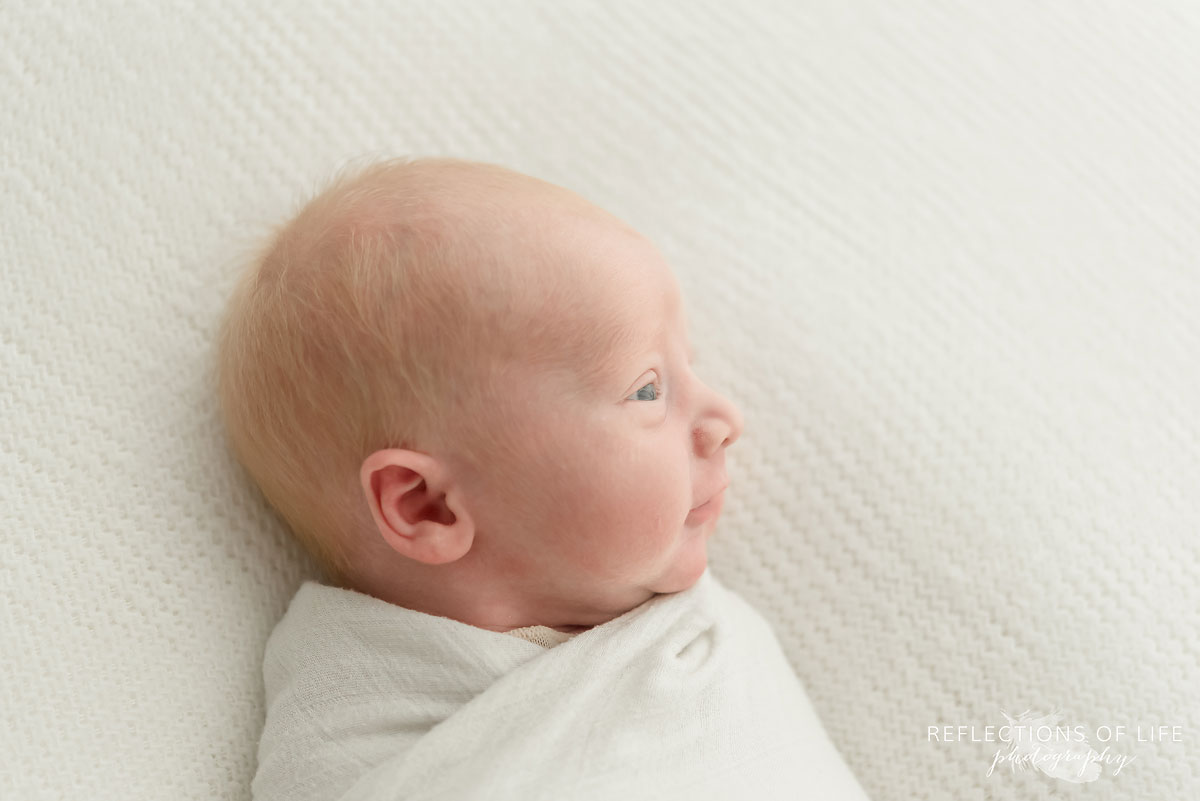 Colour side profile image of newborn baby boy